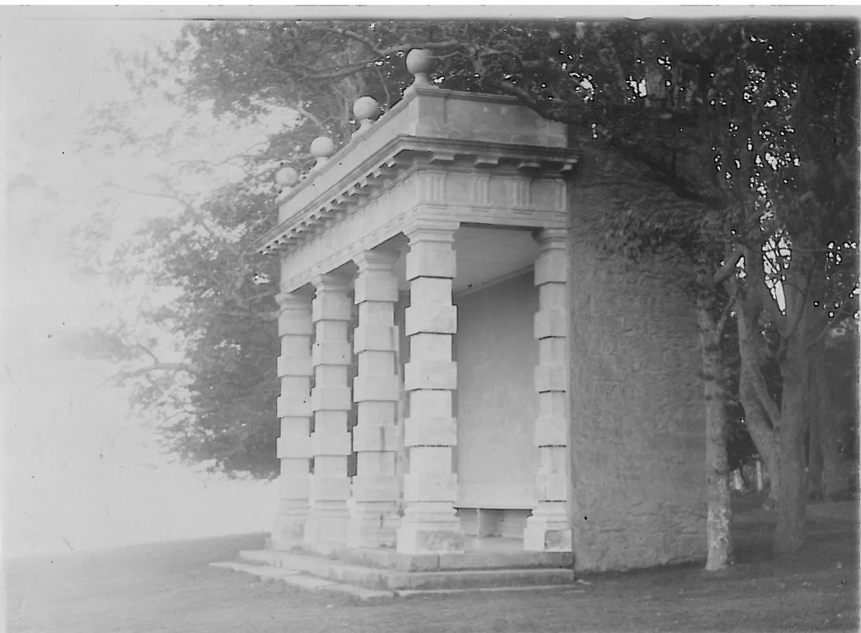 Black and white photograph of intact Harbour View Seat  c 1930. White seat has roof supported by ornate columns.