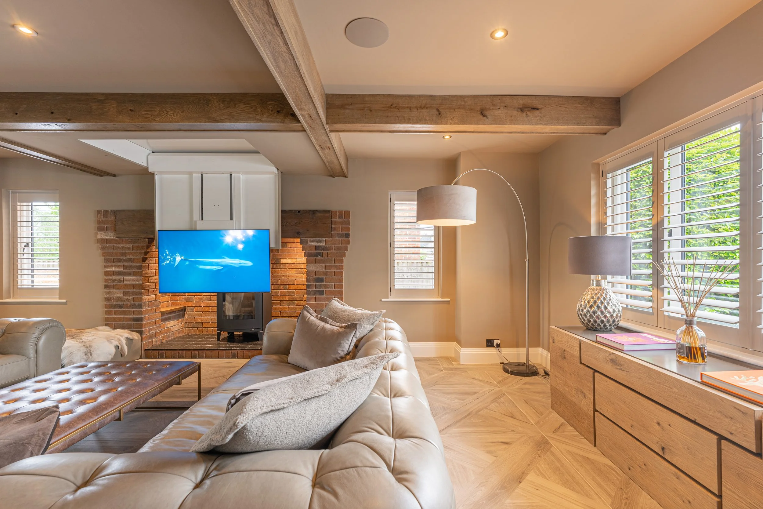 Luxury living room with integrated smart home television and discreet ceiling speakers
