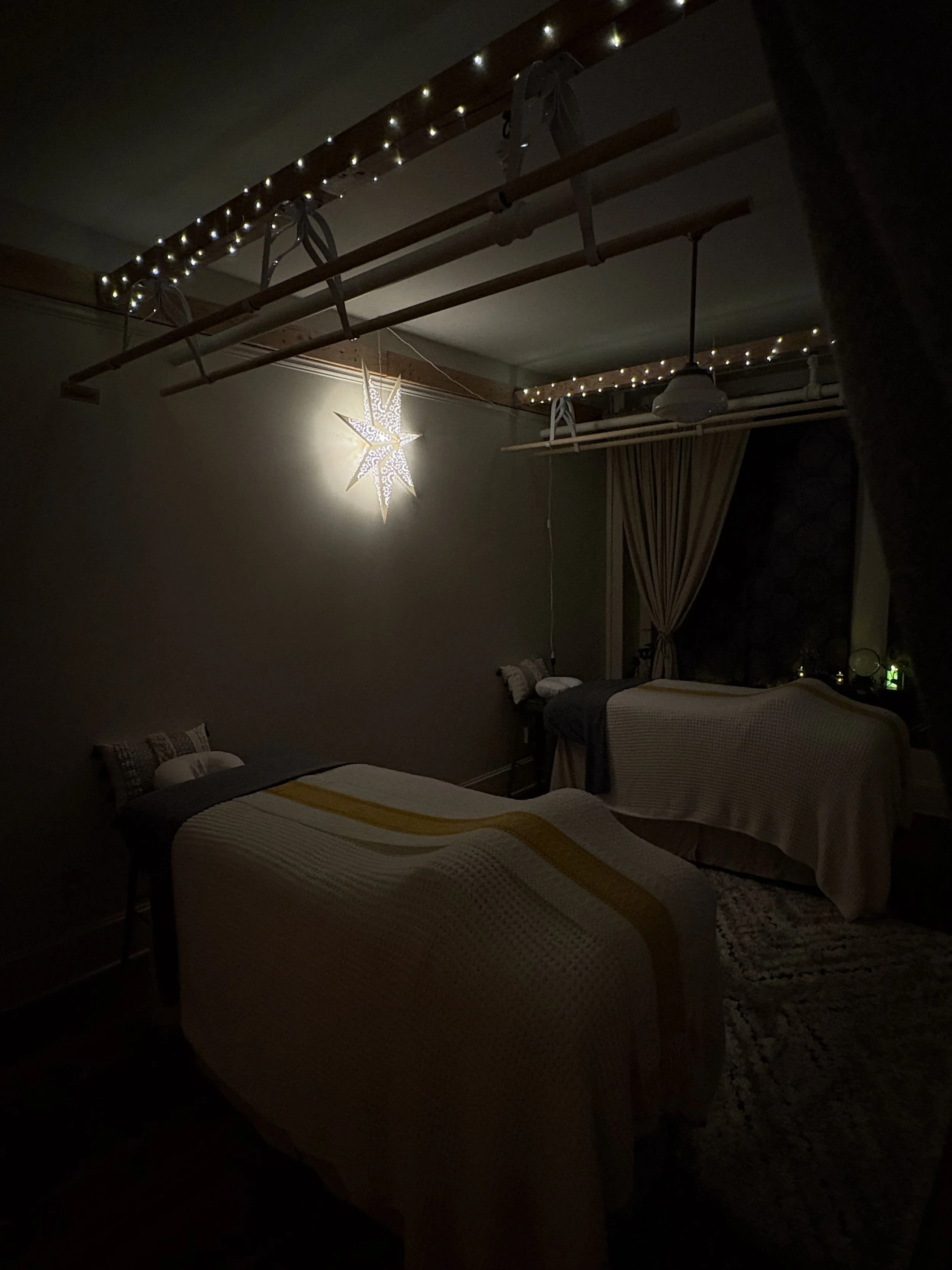 Cozy downtown Portland Ashiatsu bar therapy room with string lights at Groundspell Massage near Powell’s Books
Relaxing massage table with soft lighting at Groundspell Massage in Portland
Cozy therapeutic massage room at Groundspell Massage