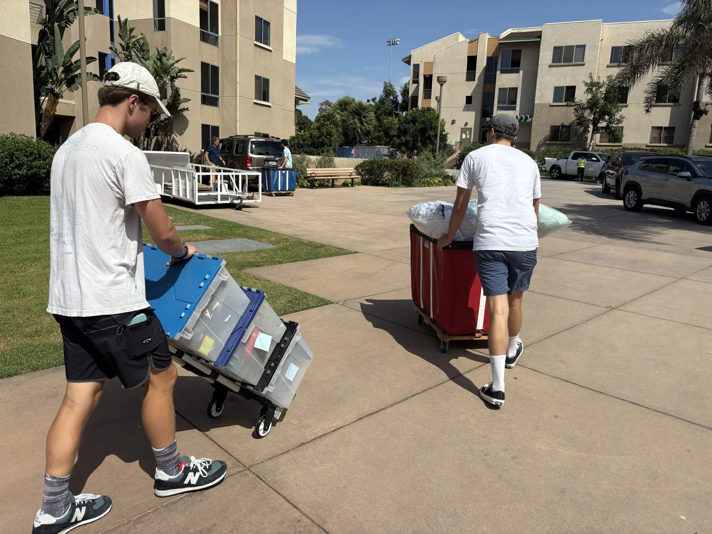 Students moving college belongings with dorm carts