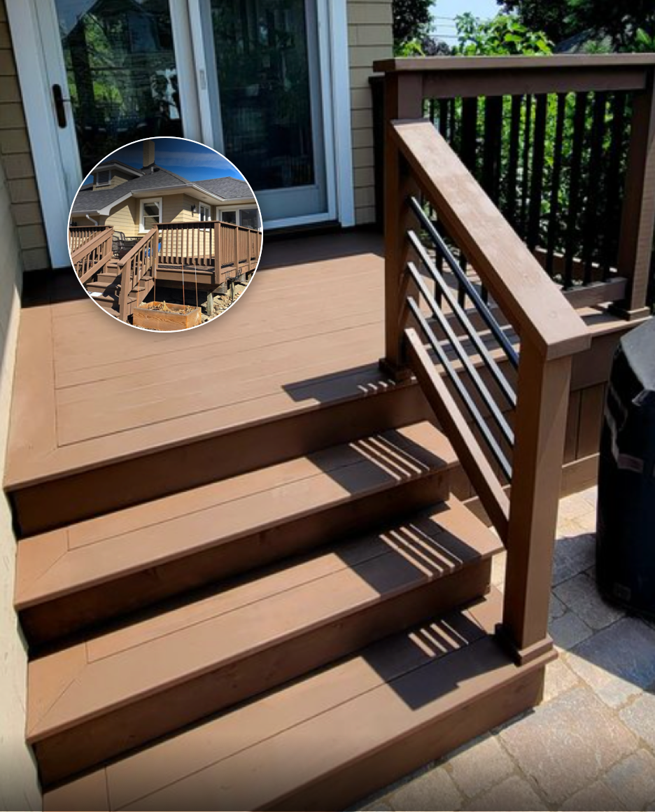 A freshly built wooden deck with stairs and railing outside a house, attached to a sliding door leading inside, with a storage bin visible on the right side.