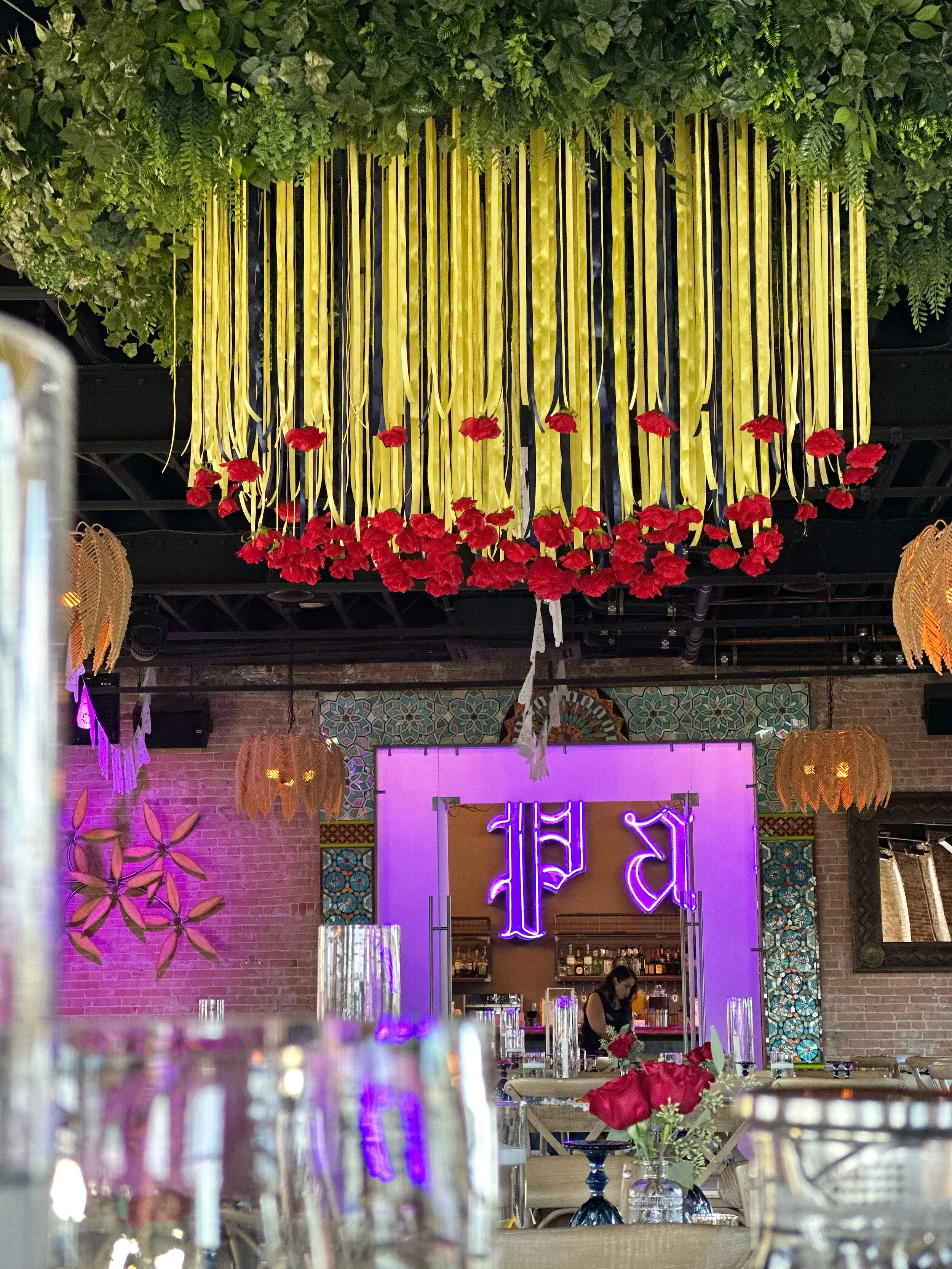 Decorative hanging yellow ribbons with red flowers.