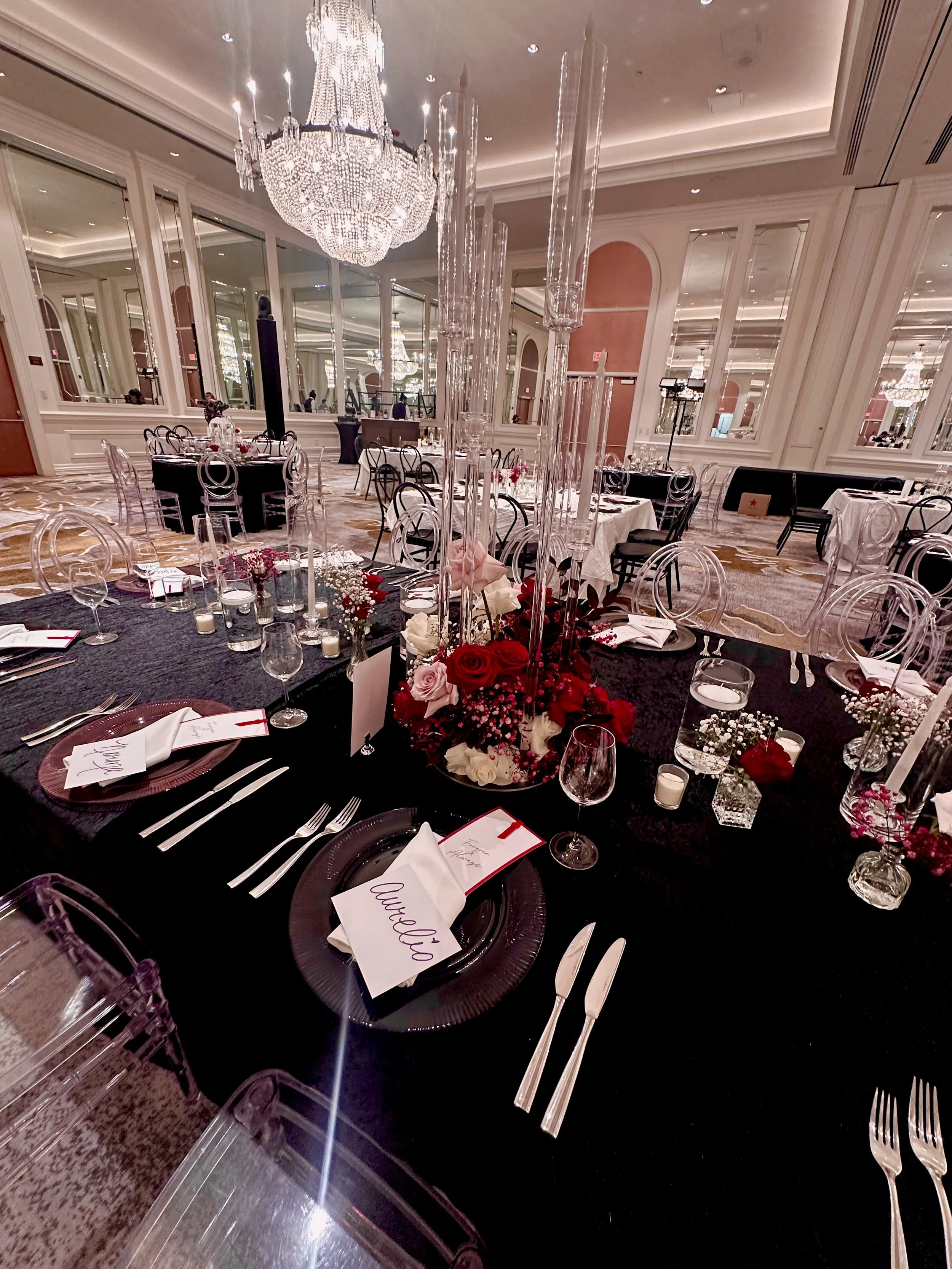 Elegant banquet hall decorated for a wedding reception with a large chandelier.