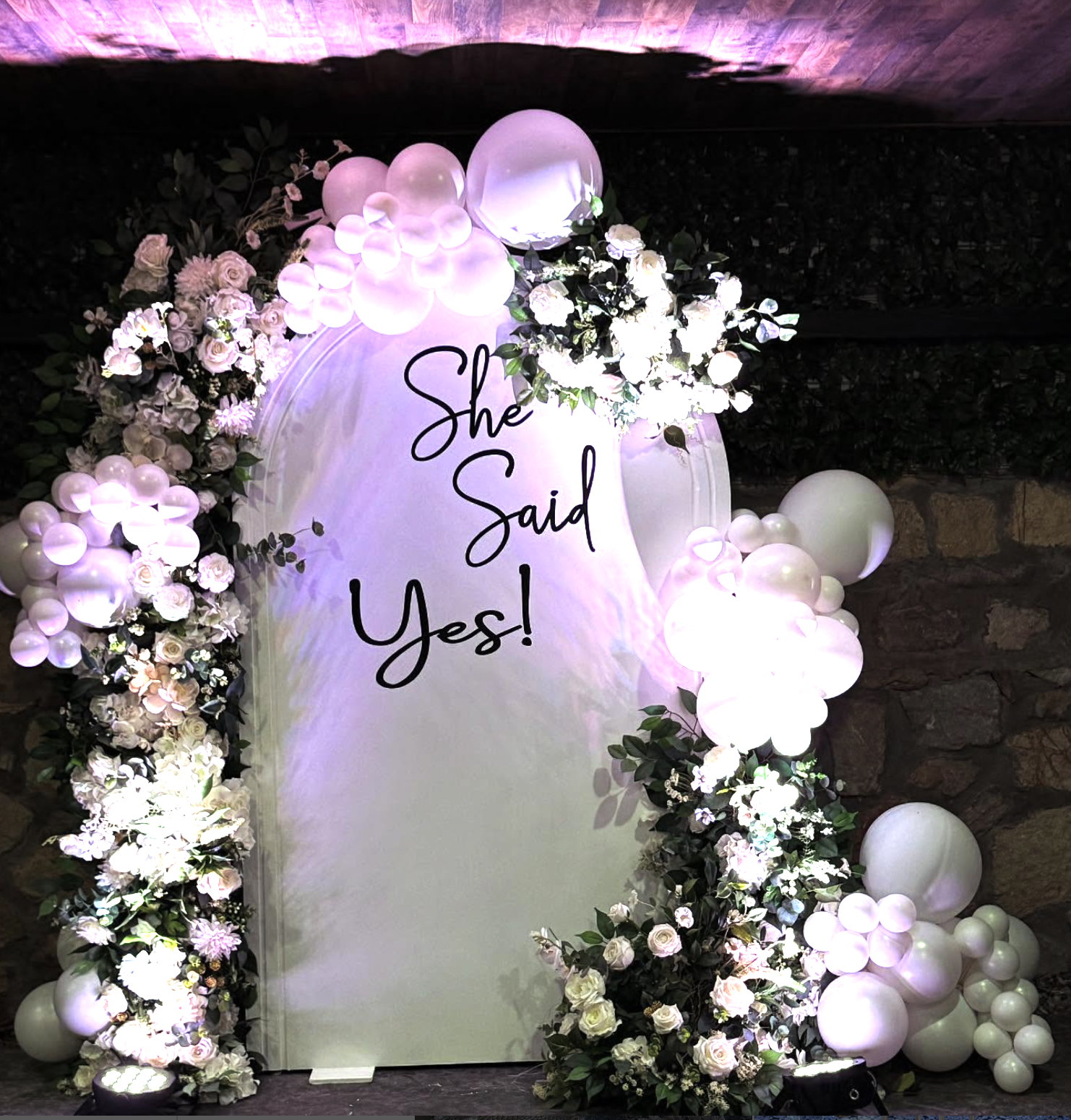 Arch featuring balloons and florals.