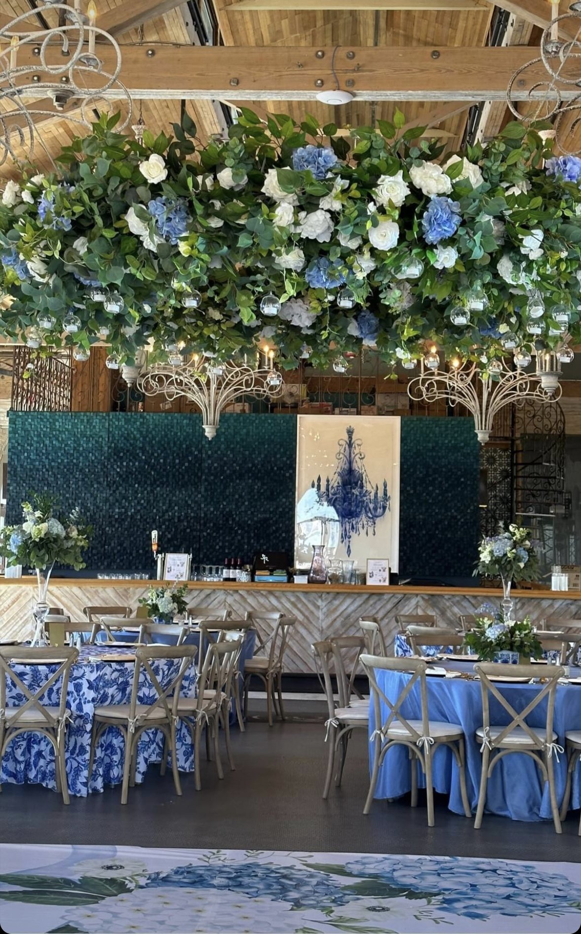 Elegant indoor event space decorated with floral arrangements.