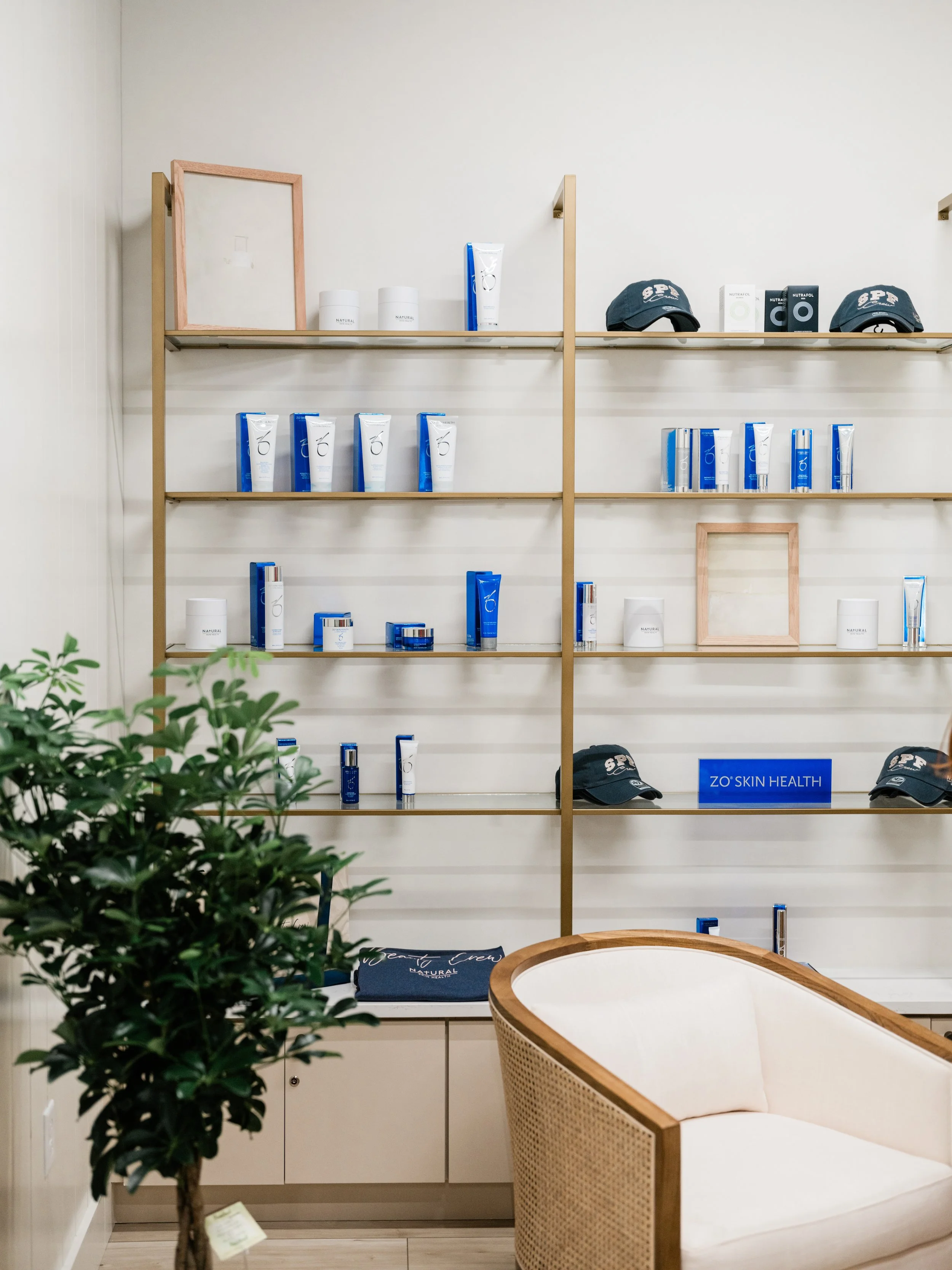 A wall shelf full of different skin care products at Natural Skin Health clinic