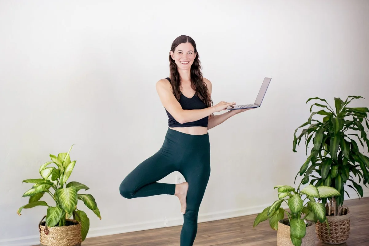 Woman smiling holding a computer