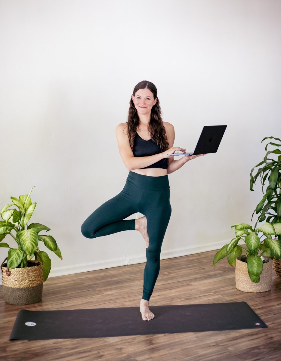 Woman smiling holding a computer