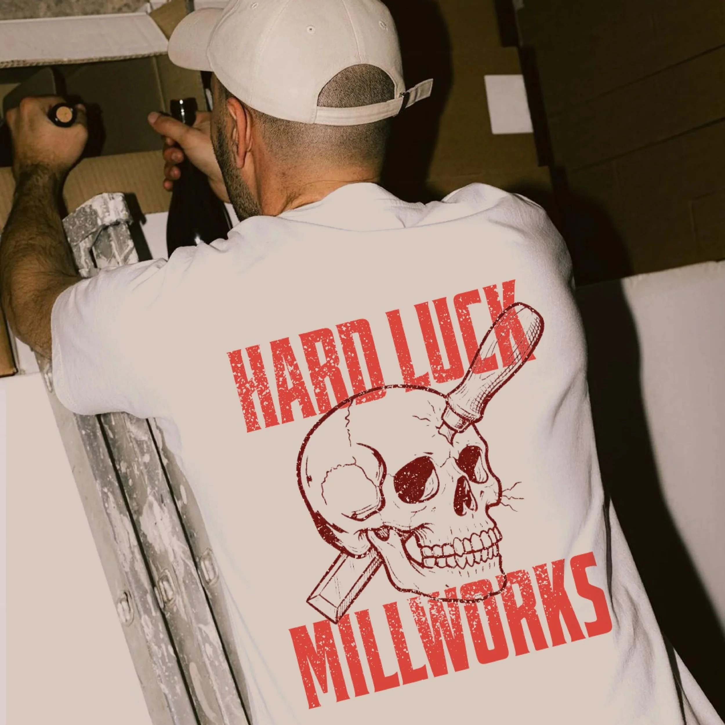 Man wearing a workwear t-shirt with graphic print on that read Hard Luck Millworks
