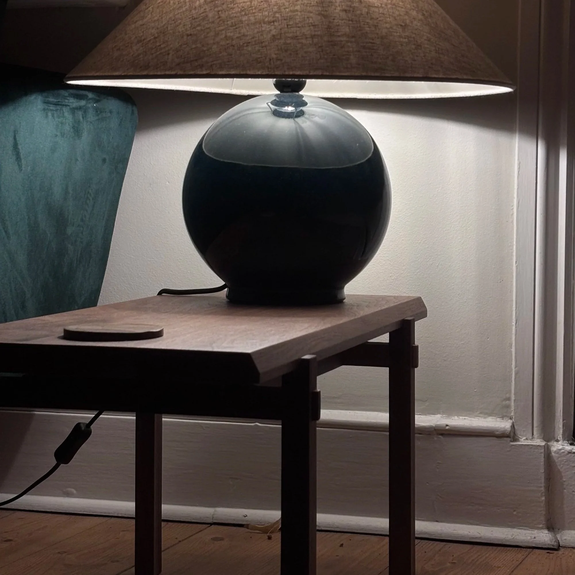 A solid walnut Japanese furniture style coffee table styled with a lamp