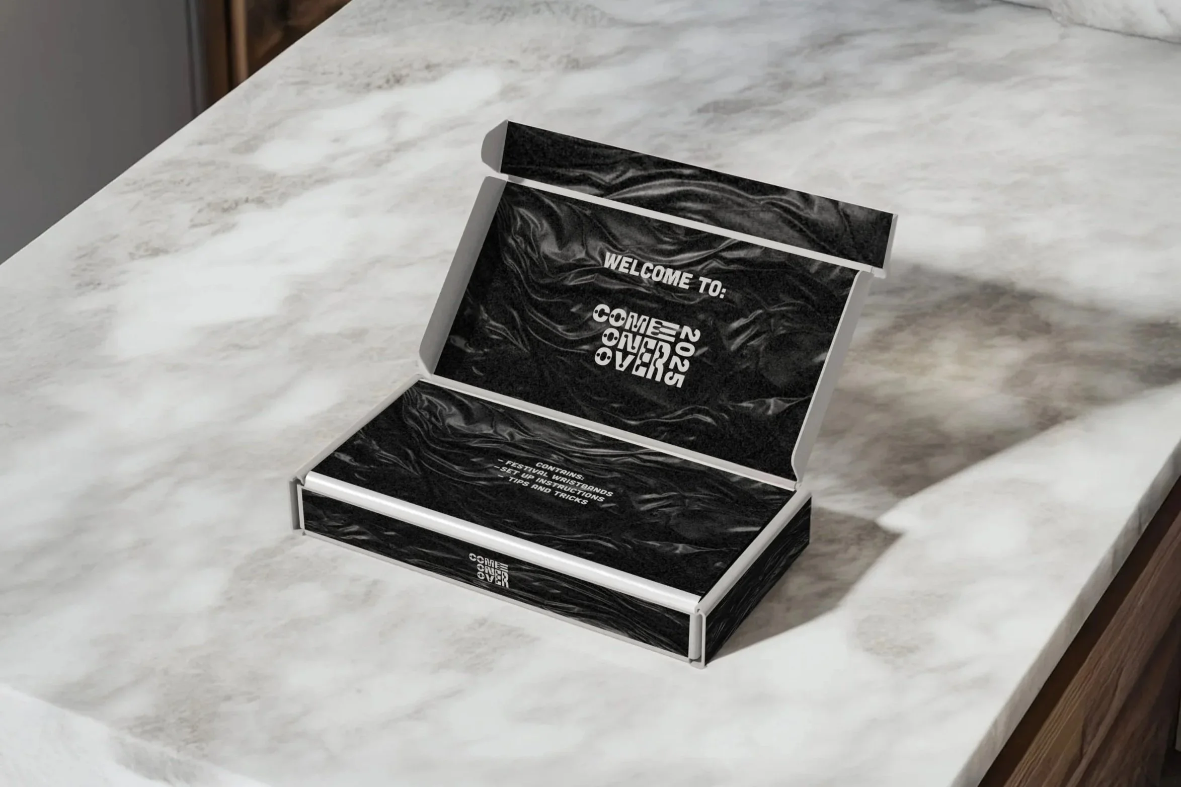 Custom wristband packaging box for the Come Over music and arts festival, showcasing branded festival collateral and experiential design by Kieren Dial.