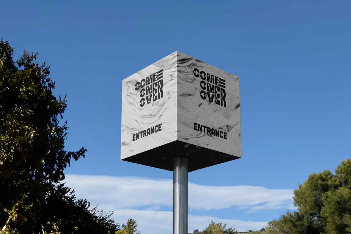 Entrance wayfinding tower for the Come Over music and arts festival, showcasing large scale environmental signage and brand system design by Kieren Dial.