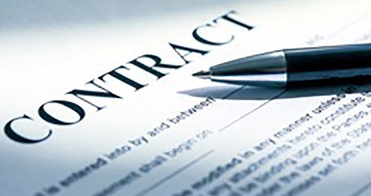 Close-up of a contract document with a pen resting on it.