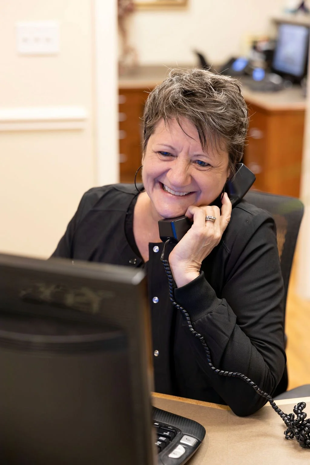Office administrator on the phone at Dr. Nason's front office