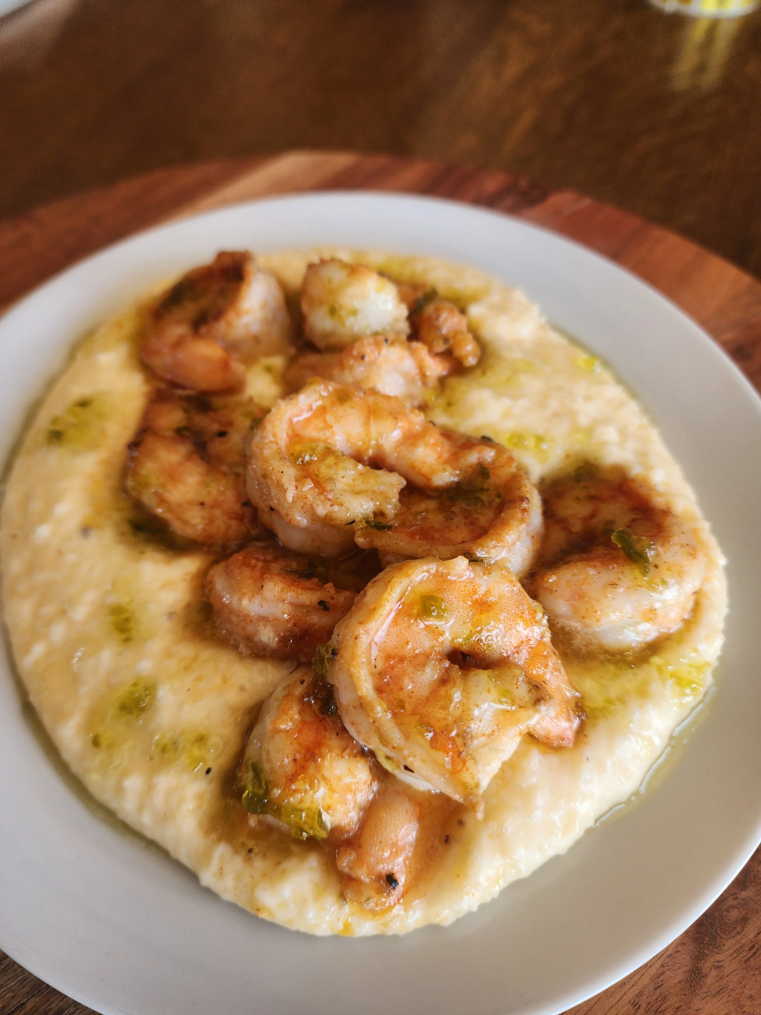 Shrimp served over creamy grits.