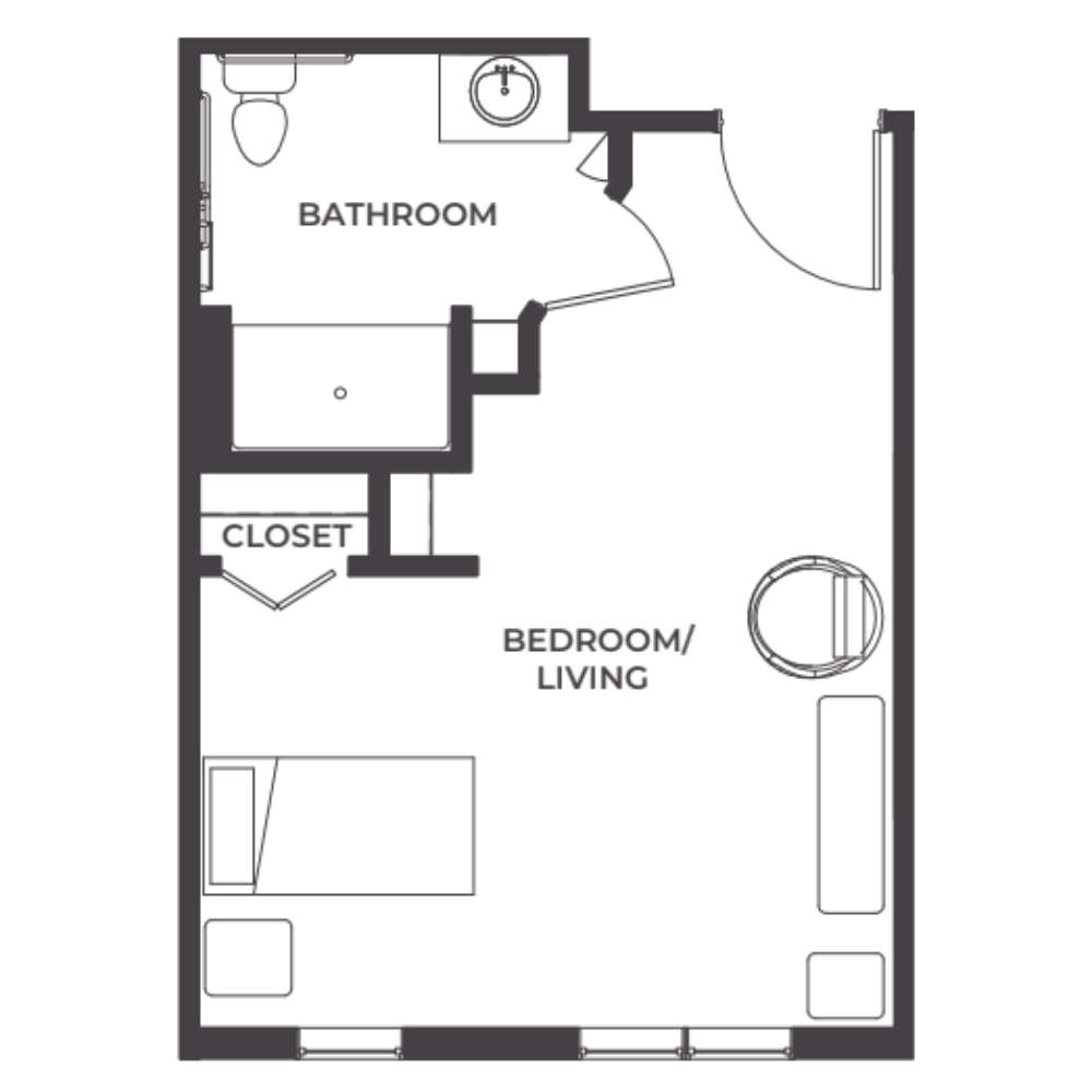 Floor plan of a small apartment showing a combined bedroom and living area, a bathroom with toilet and sink, a closet, and a window.