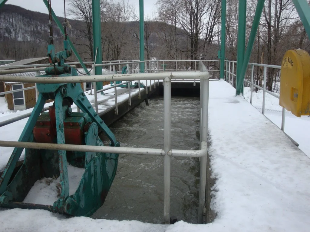 5. Aerated Grit Chamber:
Following screening, raw wastewater is pumped to the aerated grit chamber (AGC). Two 7.5-horsepower blowers supply air to the chamber through an air header at the bottom of the tank, where the air is discharged through a seri