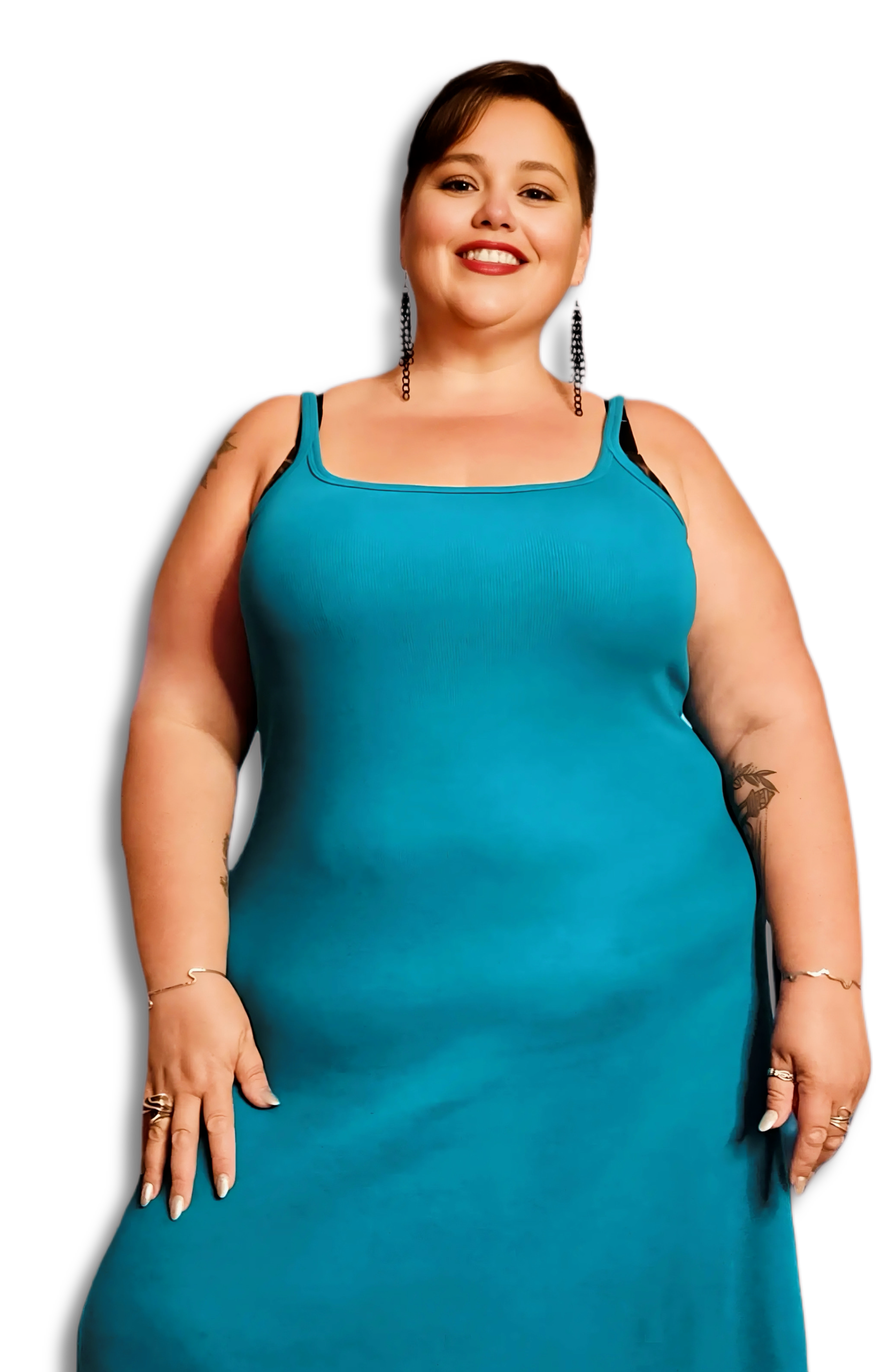 Toronto service provider Lush Lynn with short brown hair, wearing a blue dress with thin straps and black undergarments, standing against a black background.