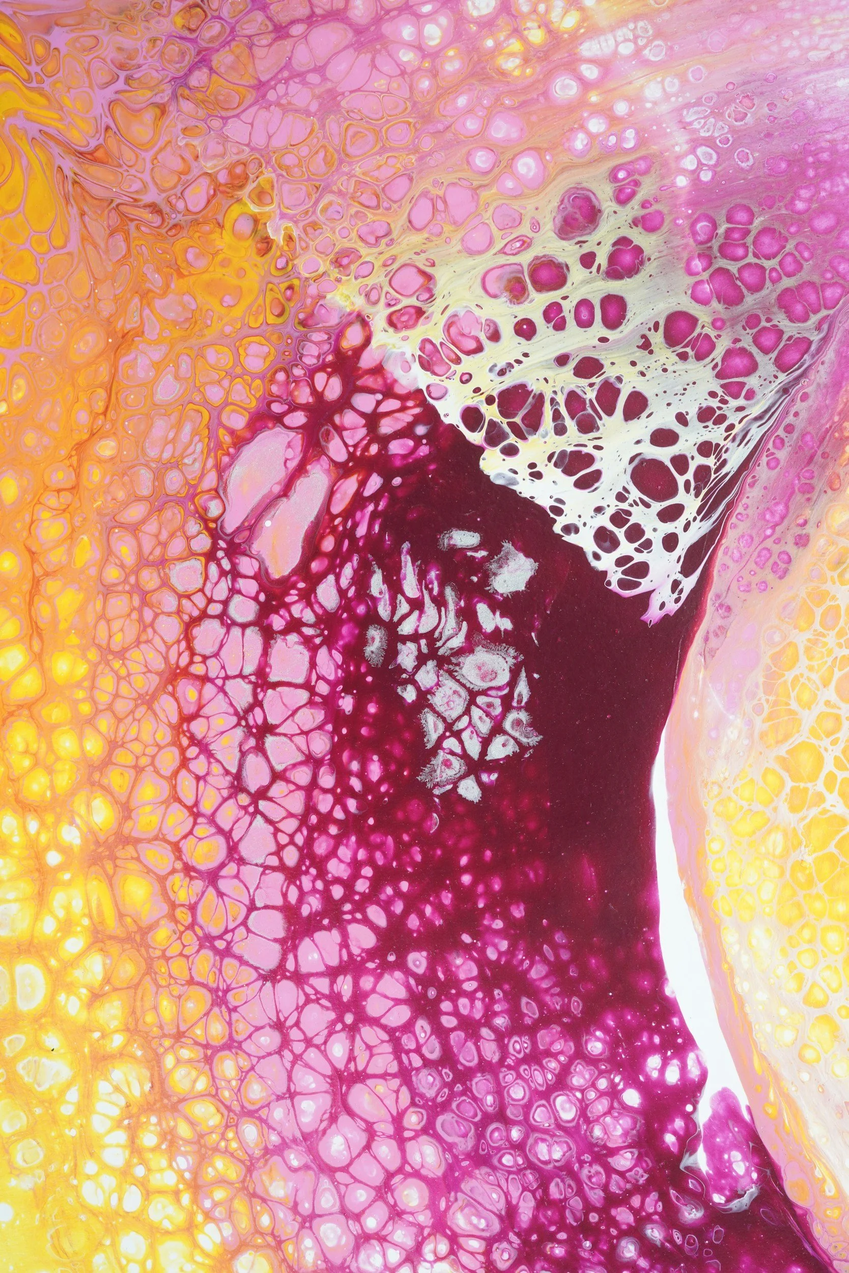 Abstract fluid art painting with pink, yellow, red, and white tones showing cellular patterns and lace-like textures.