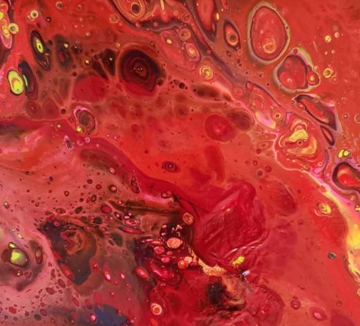 Abstract image with red, yellow, black, and pink swirling patterns and bubbles.