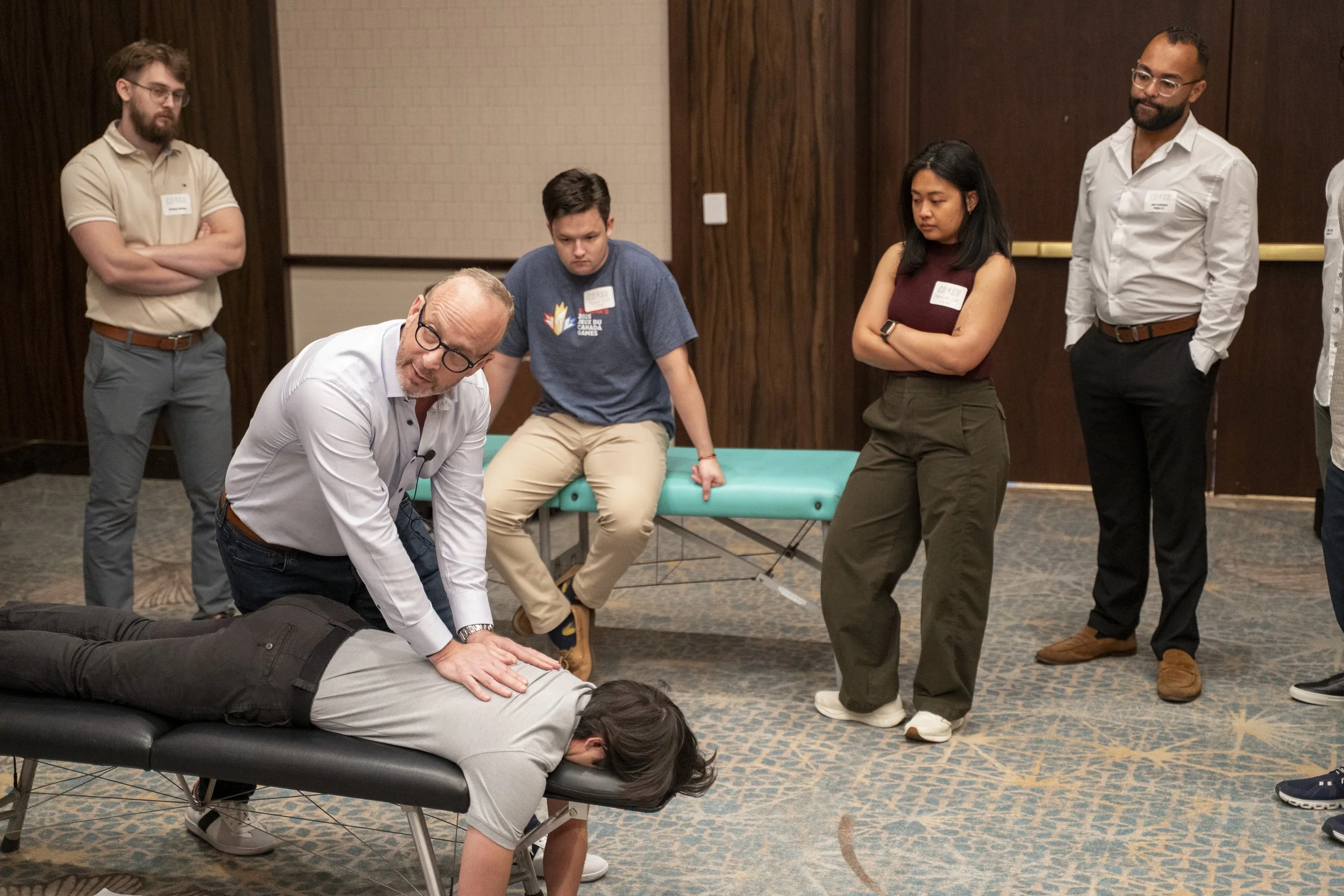 Dr. Eric Russell teaching during a hands-on chiropractic training and educational event.