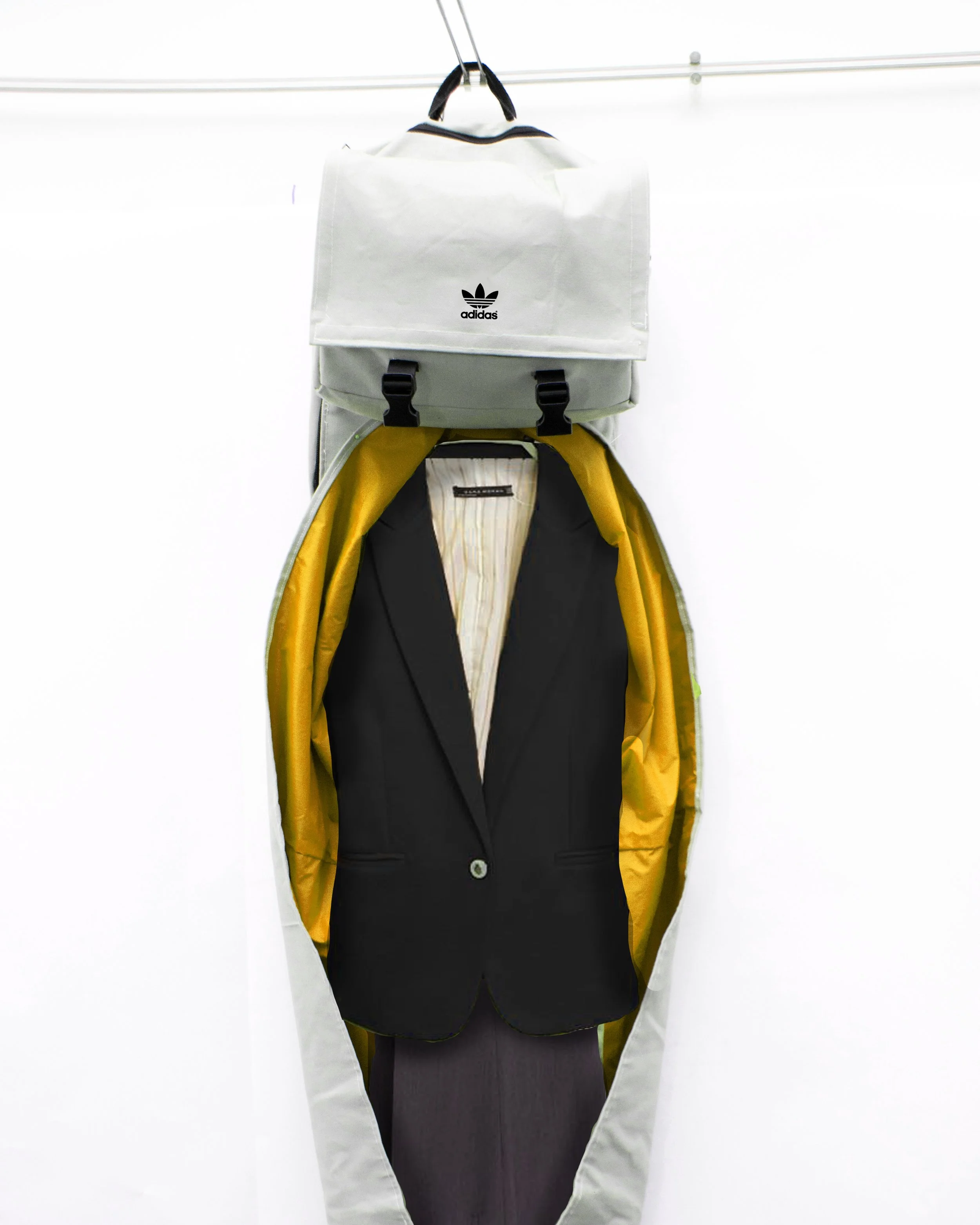 A black blazer hanging on a hanger inside a yellow garment bag, with a gray Adidas backpack hanging above on a hook against a white background.