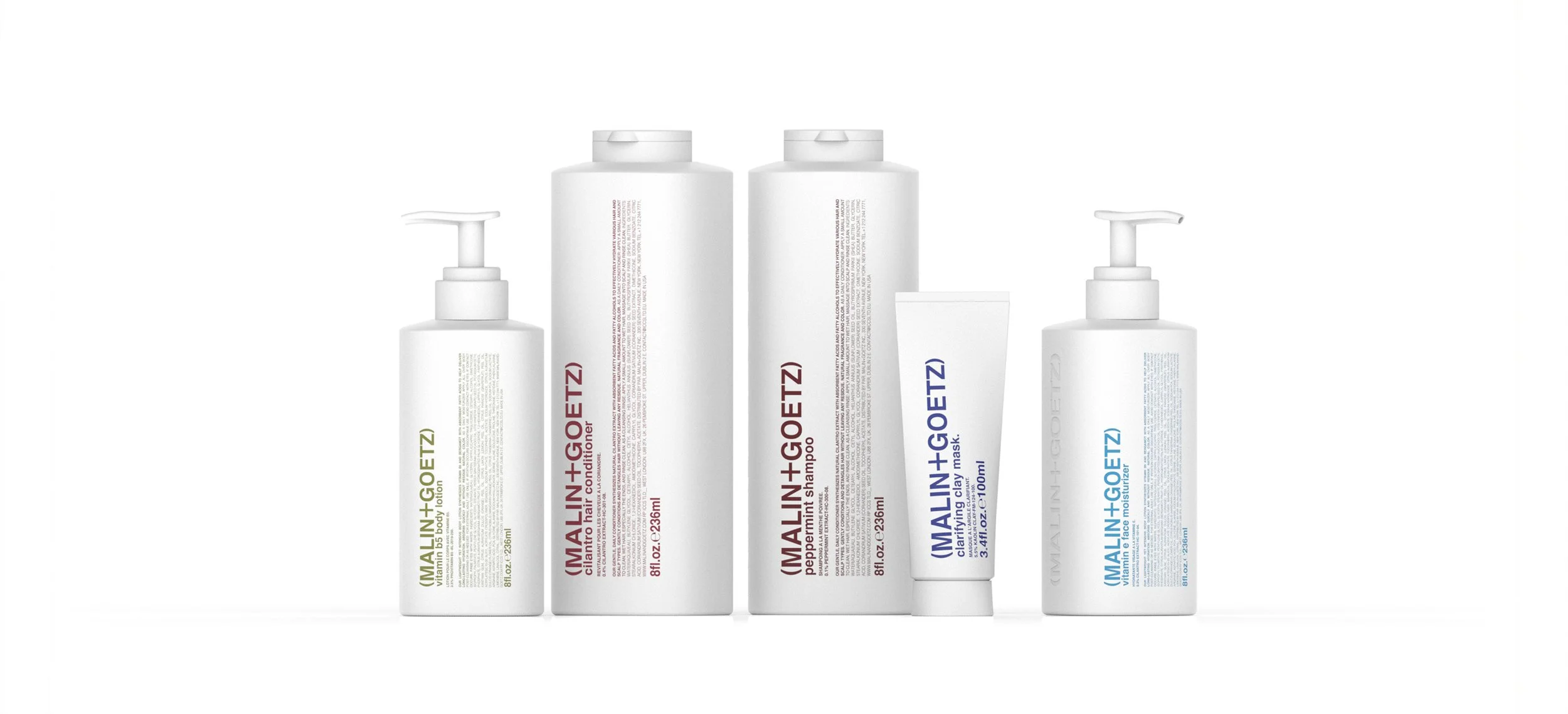 Collection of Malin + Goetz skincare products including body lotion, conditioner, shampoo, face mask, and moisturizer, arranged on a white background.