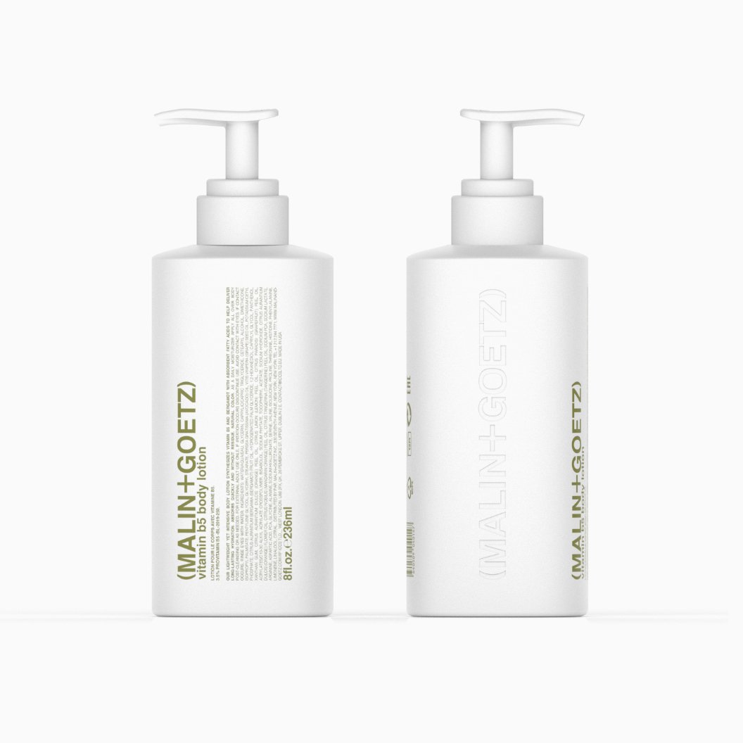 Two white bottles of Malin + Goetz Vitamin B5 Body Lotion with pump dispensers, standing side by side on a white background.