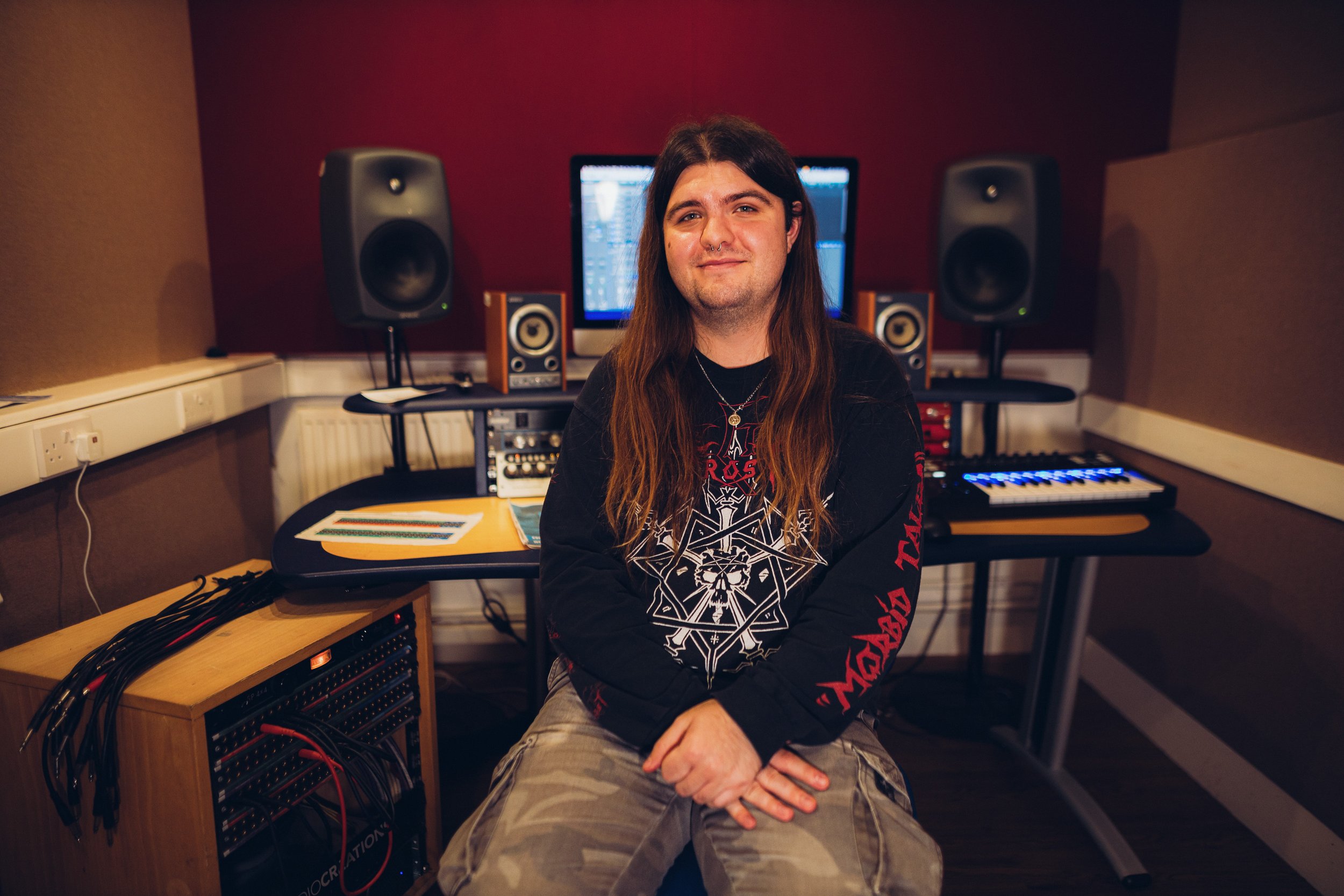 Ben sat facing the camera in a small recording studio