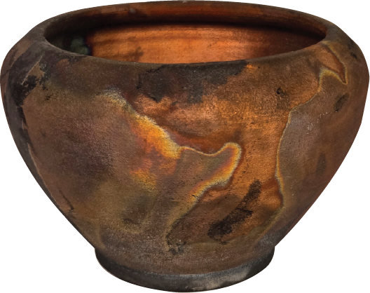 A large, round clay pot with a weathered, rustic appearance and multicolored surface in shades of brown, orange, and black.