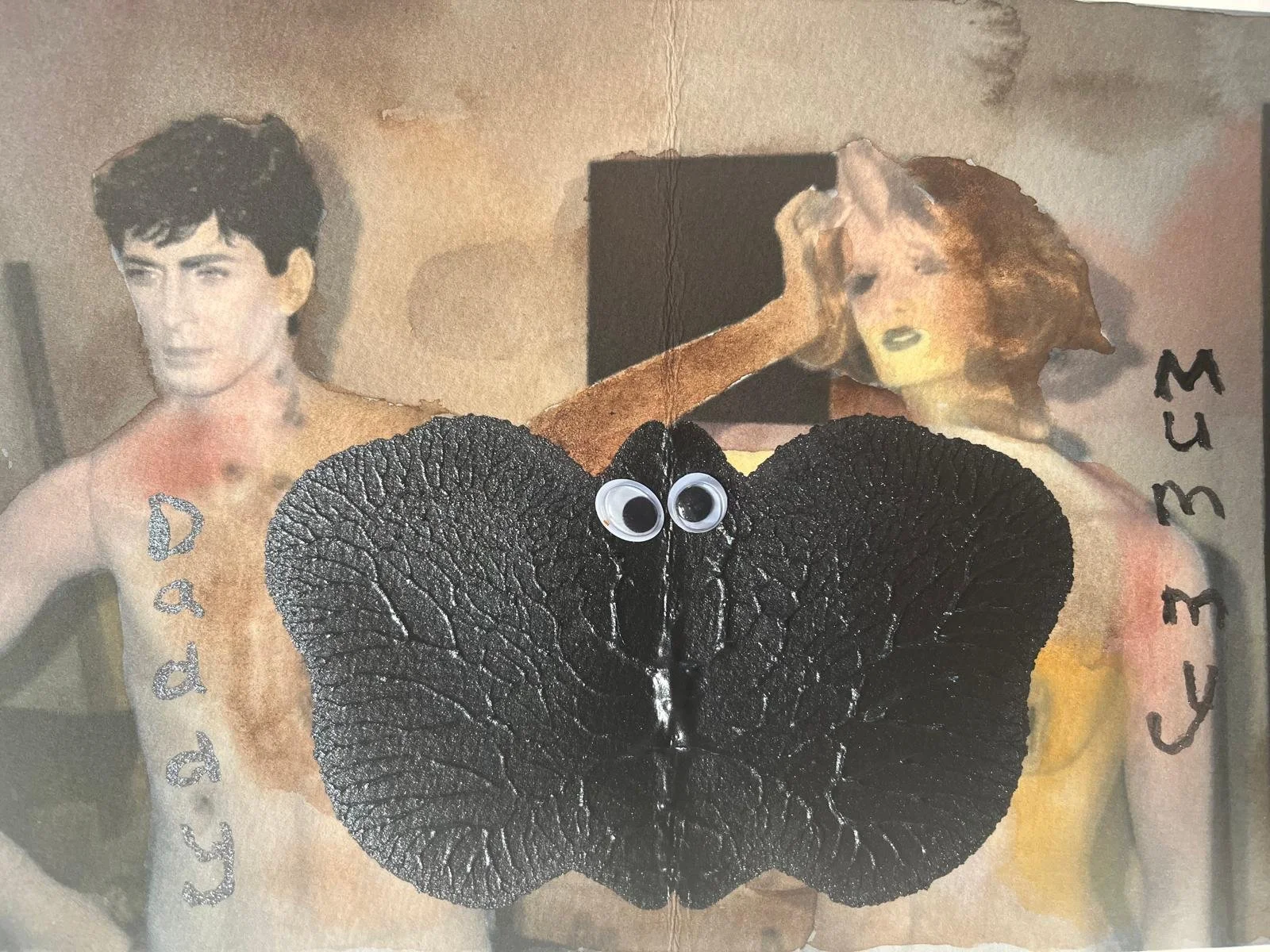 A collage featuring two shirtless individuals, one male and one female, with a large black butterfly in the center, with googly eyes attached to it. The male has dark, short hair and the female has longer, curly hair. The words "Daddy" and "Mummy" ar