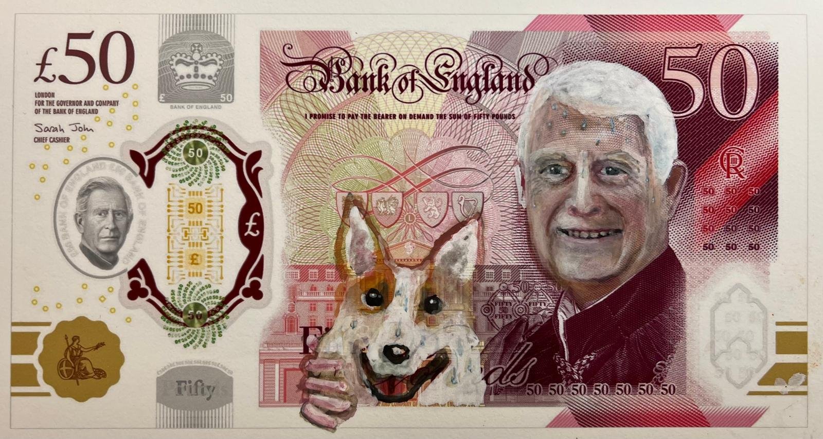 A 50-pound banknote with a painted portrait of a smiling man and a dog giving a thumbs up. The banknote features various security elements, the Royal Coat of Arms, and British symbols.