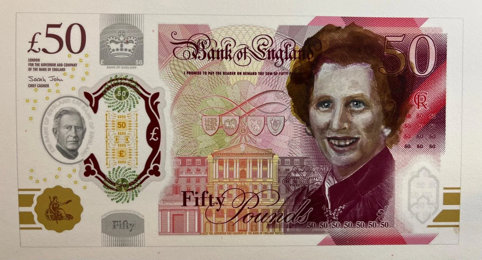 A fifty-pound banknote from England featuring a portrait of Queen Elizabeth II, various security features, and intricate designs.
