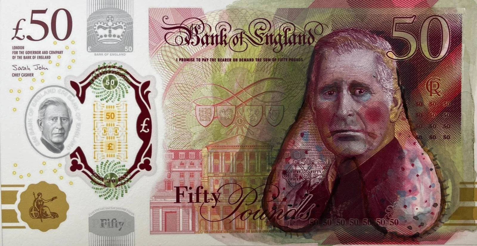 A fifty-pound banknote from the Bank of England featuring a portrait of Queen Elizabeth II on the right side, various symbols, buildings, and text including the denomination and the signature of Sarah John, Chief Cashier. The note is predominantly re