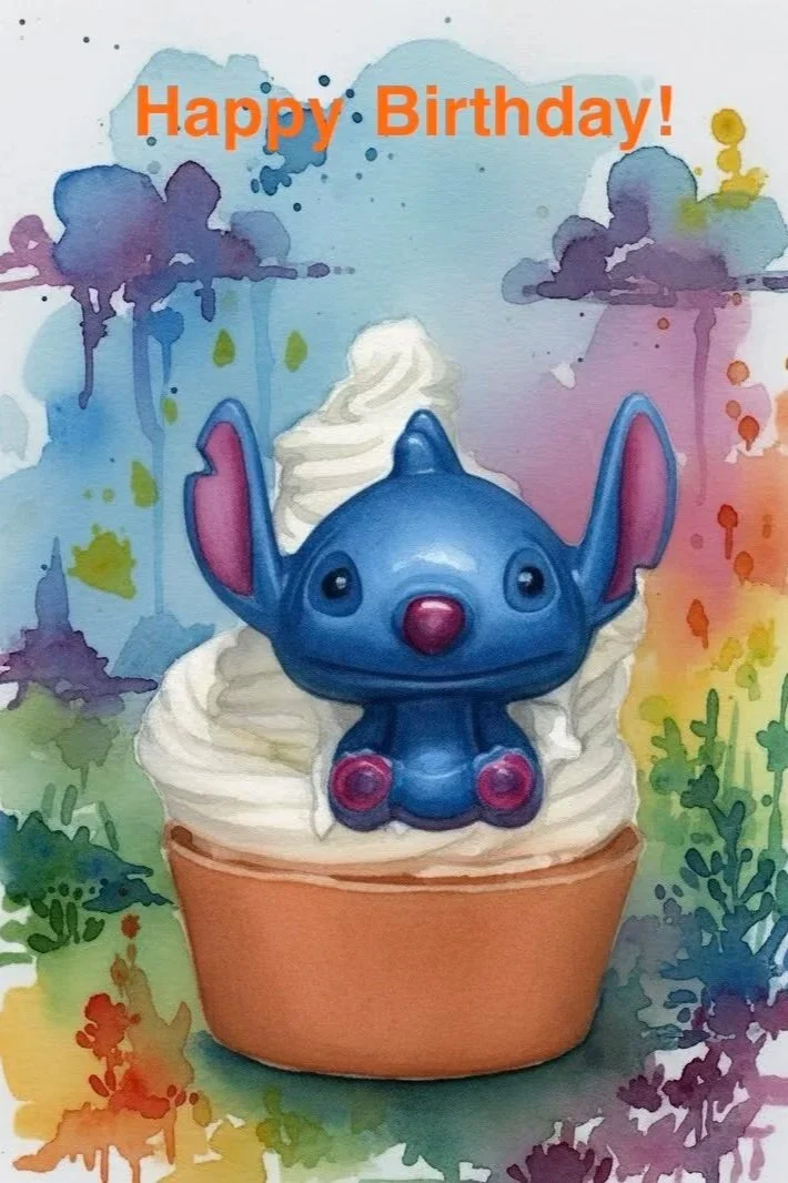 Watercolor birthday image featuring a blue cartoon character sitting on a frosted cupcake, surrounded by colorful paint splashes with “Happy Birthday!” in bright orange text at the top.