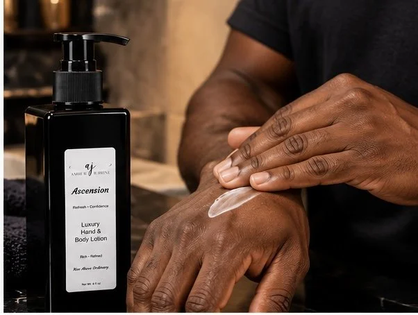 Man applying Amber Jerrine Ascension Luxury Hand & Body Lotion to his hands, with the black 8 oz pump bottle displayed beside him in an elegant bathroom setting.