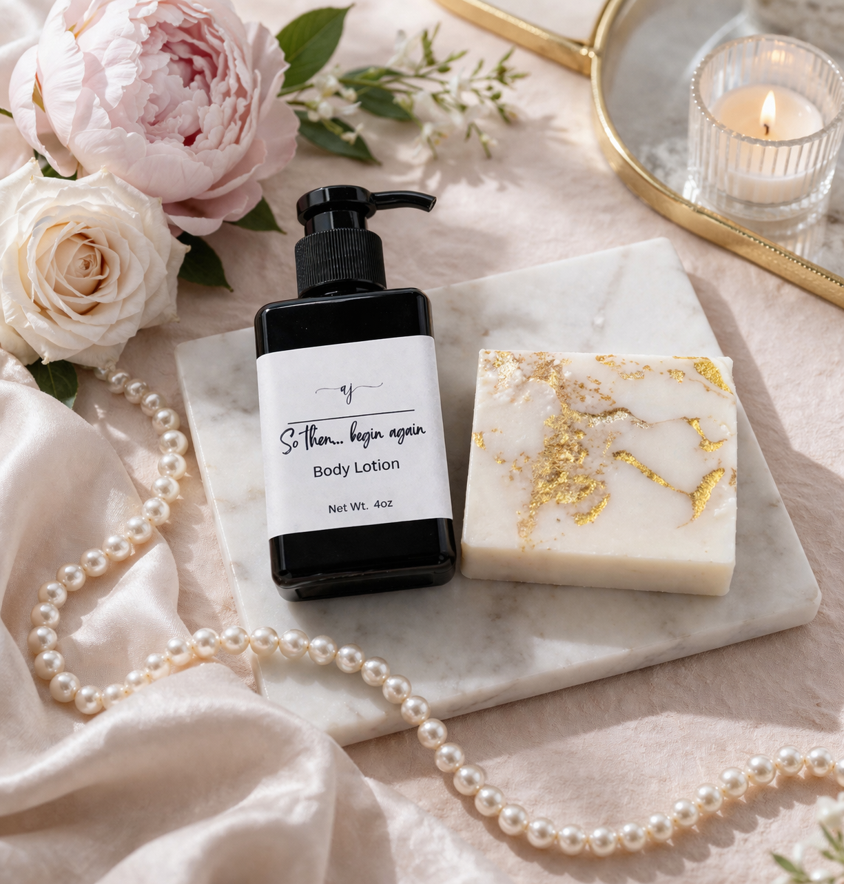 Luxury body lotion and handmade soap gift set on gold tray with silk fabric, pearls, and soft florals, creating an elegant spa-inspired self-care scene.