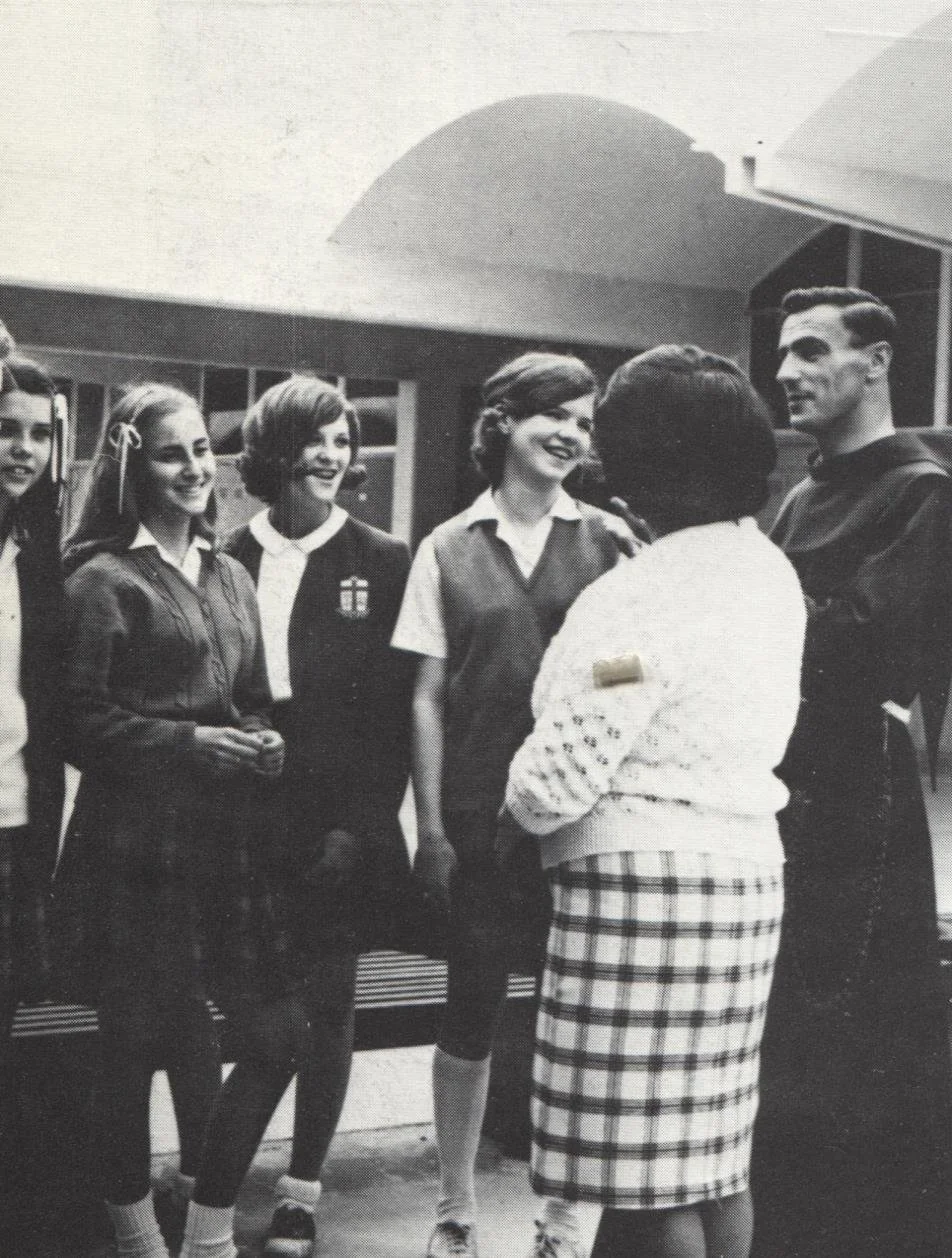 A priest speaks to a group of high school students in the late 1960s