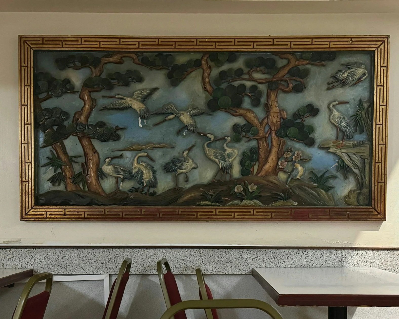 Traditional Asian-style wall art depicting various cranes and trees with flowers.