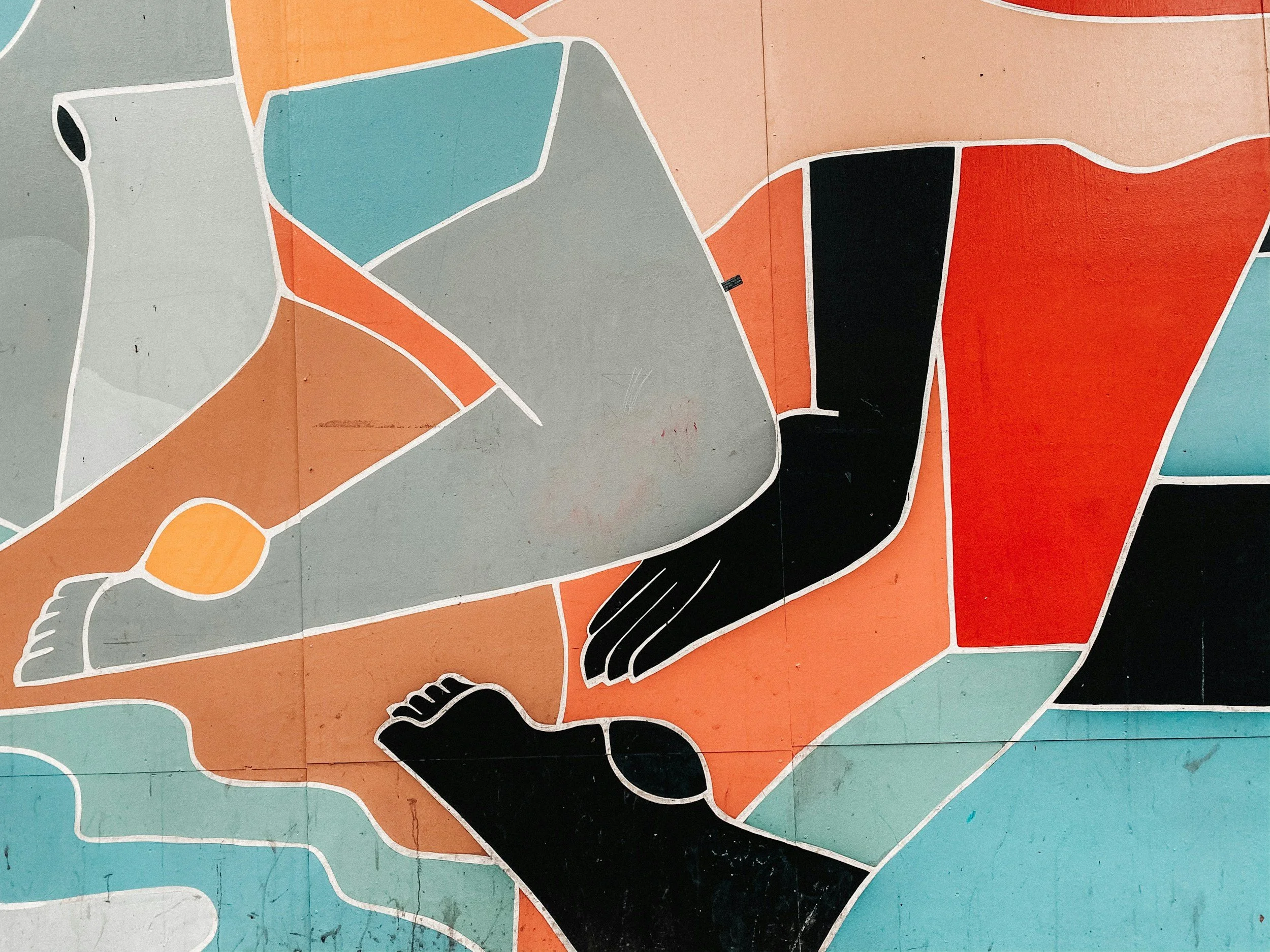 Abstract mural with colorful geometric shapes, including a stylized black hand and a foot, in shades of red, orange, teal, and gray.