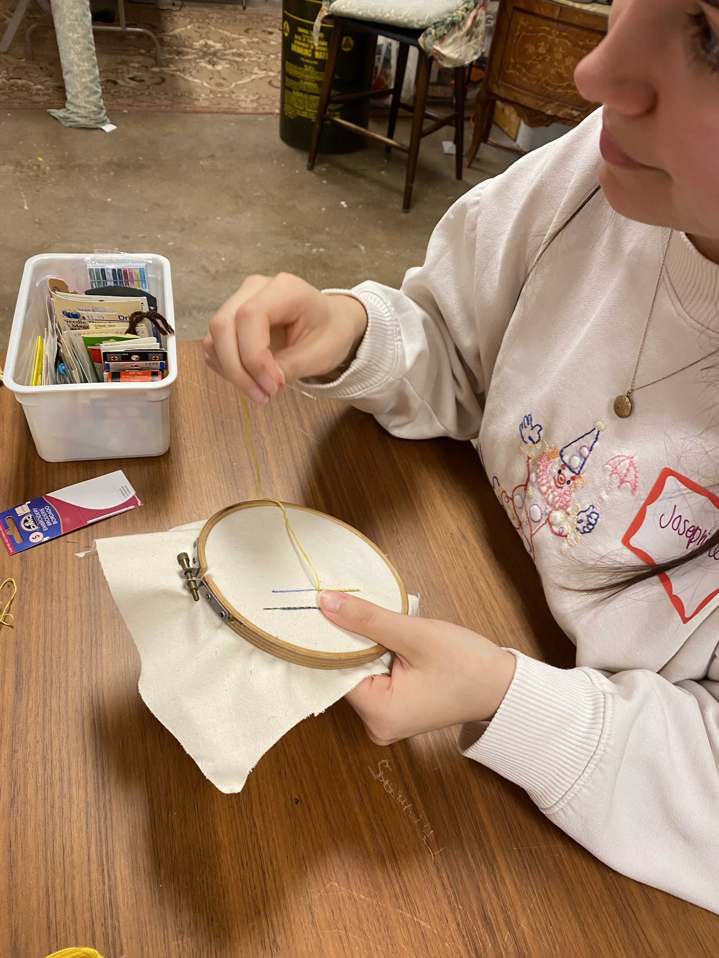 Instructor Josephine wears her art