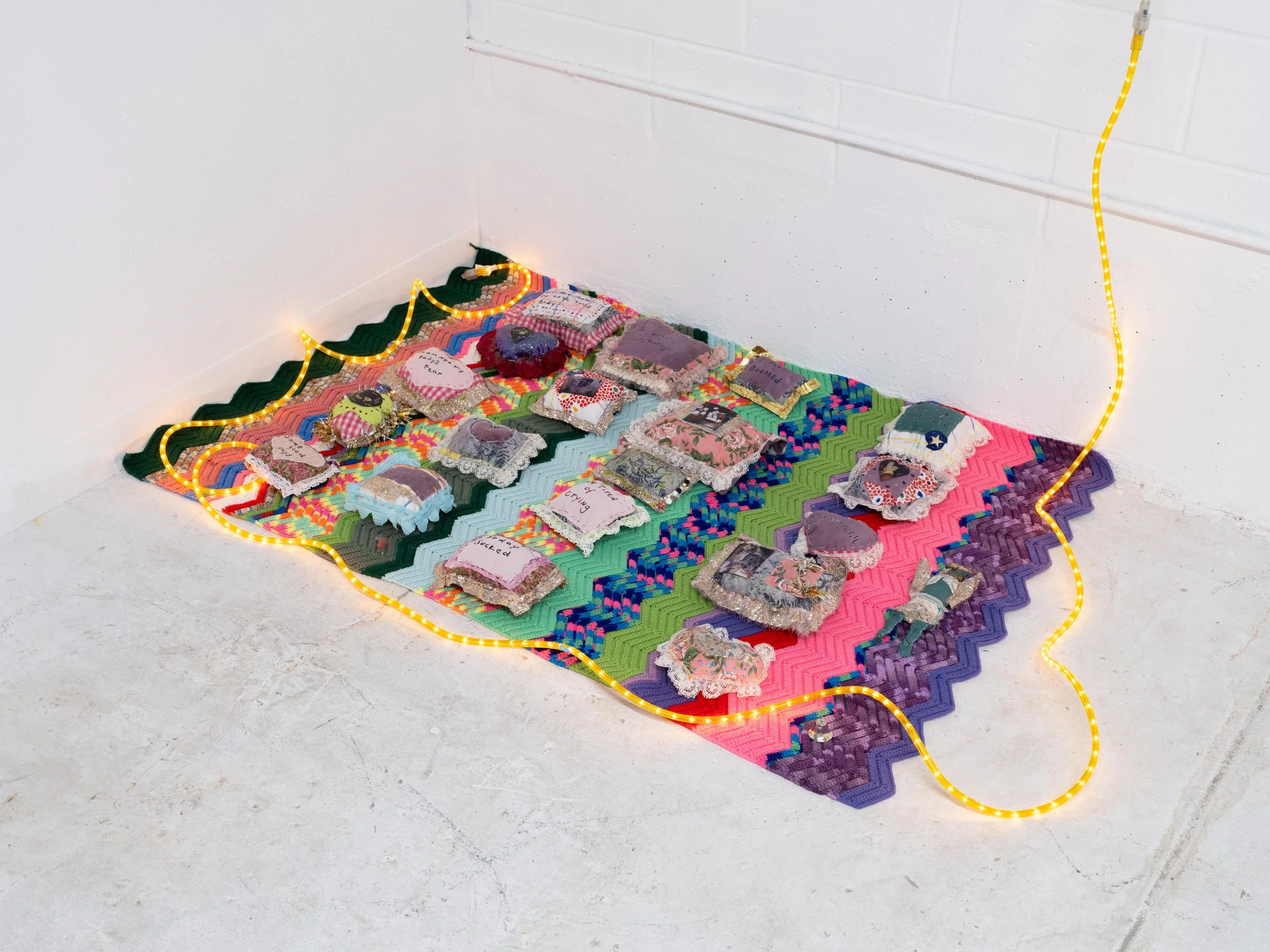 They looked like headstones, or tell me how to love this body...

Small pillows made post surgery in my bed, Glitter, Photos, Blanket and Lights.

2026