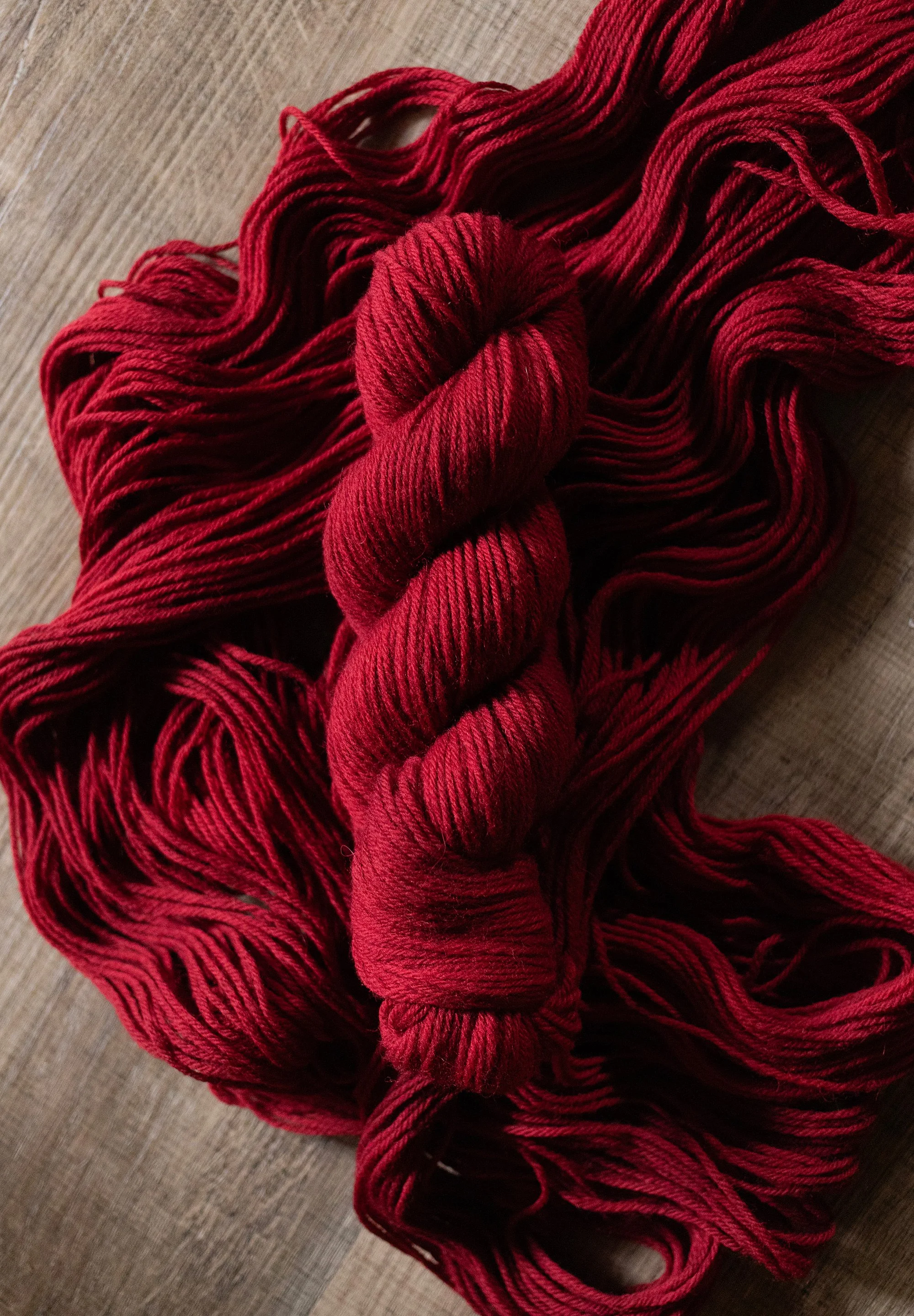 rich cherry red wool yarn. pictured on the highlands yarn base