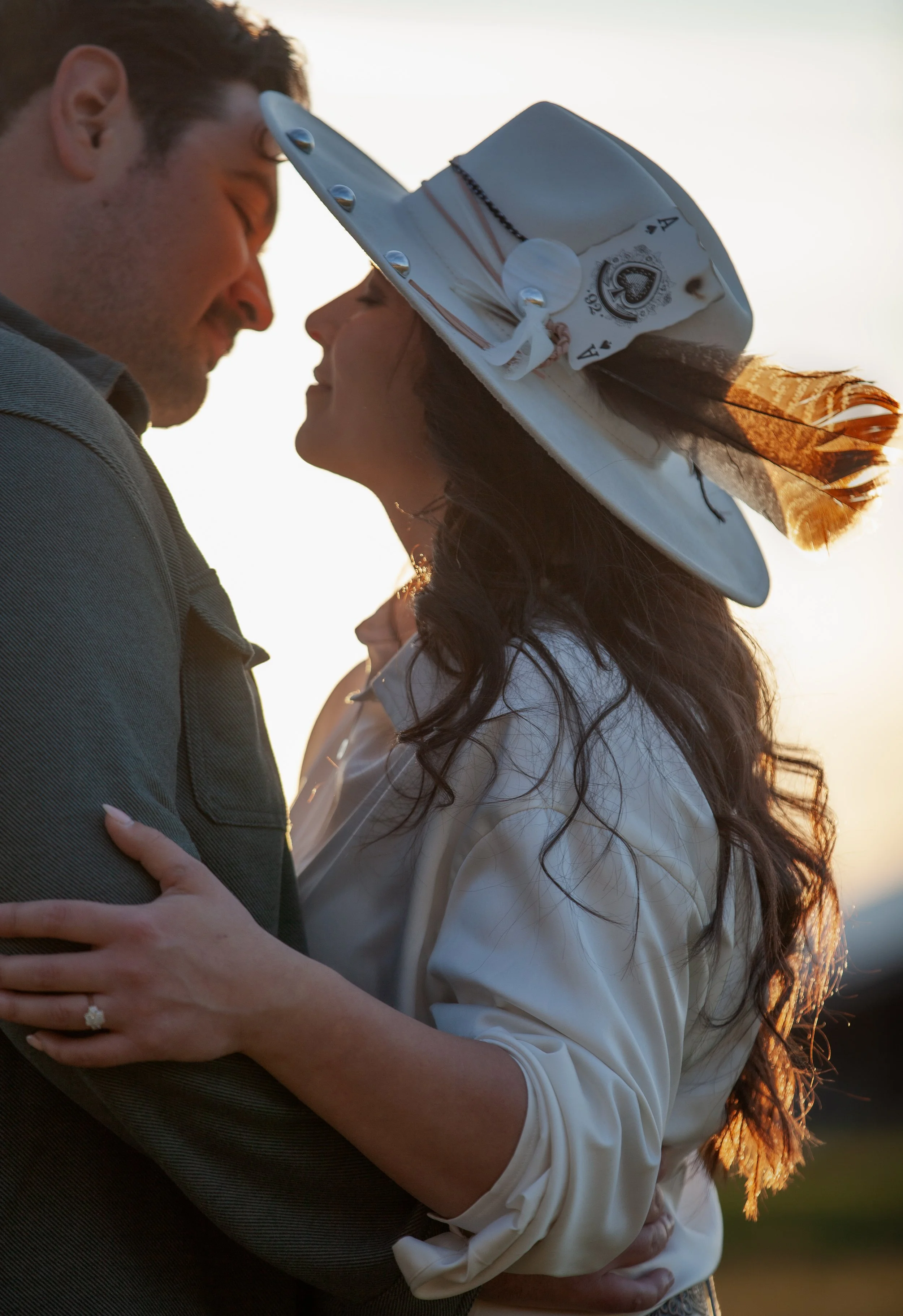 Engaged couple silhouetted in warm sunset light during their private ranch engagement photos in Central Oregon.