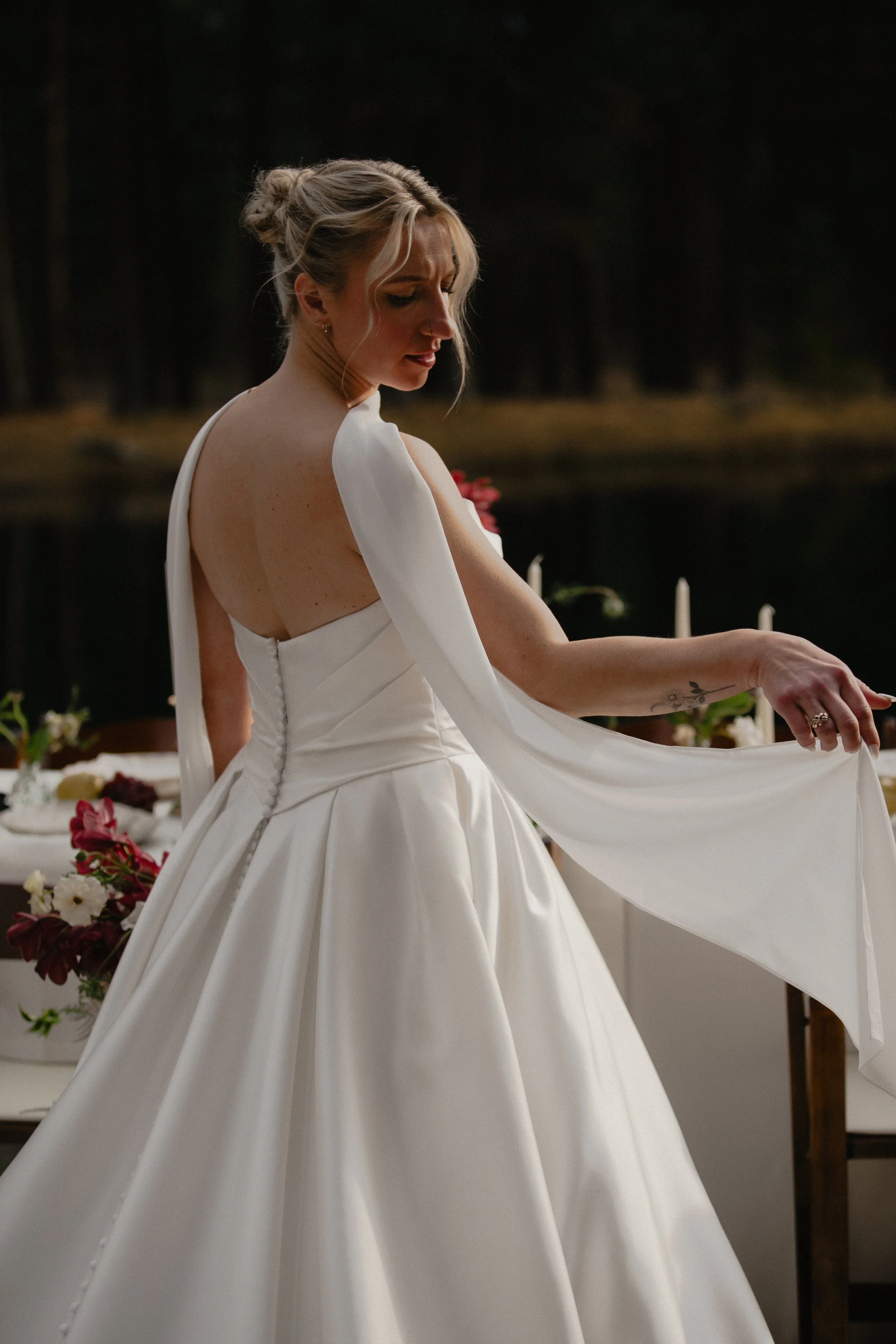Golden-light bridal portrait beside a candlelit wedding table at Lake Creek Lodge in Central Oregon.