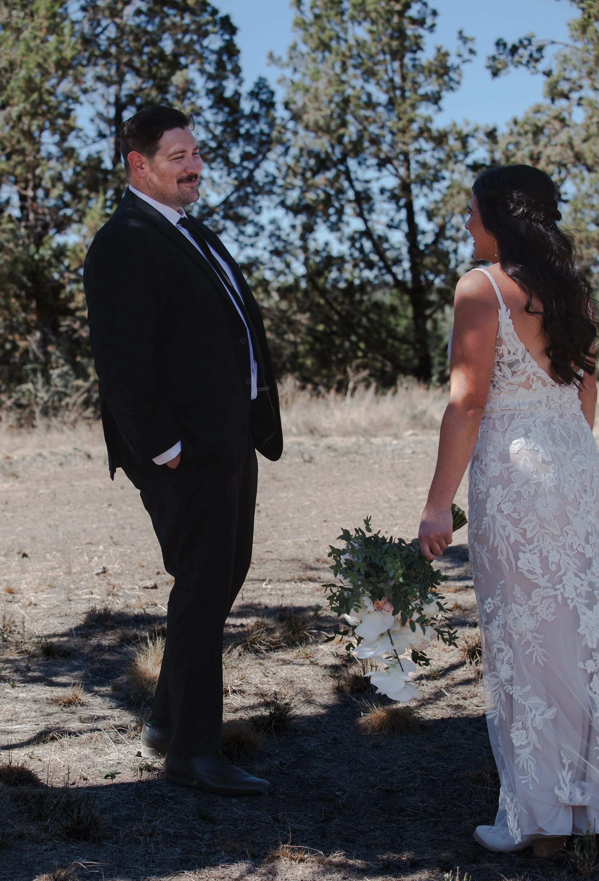  Bride and groom sharing a quiet moment during first look before their outdoor ranch wedding ceremony in Central Oregon 