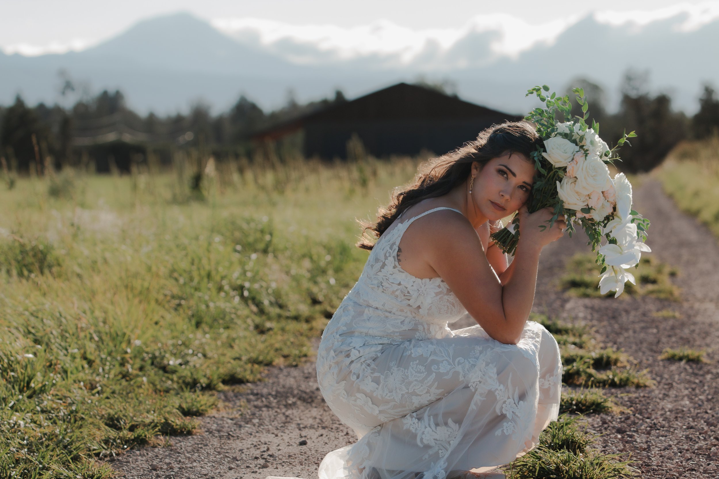  Editorial bridal portraits with white flowers and mountain views at a private ranch wedding in Central Oregon 