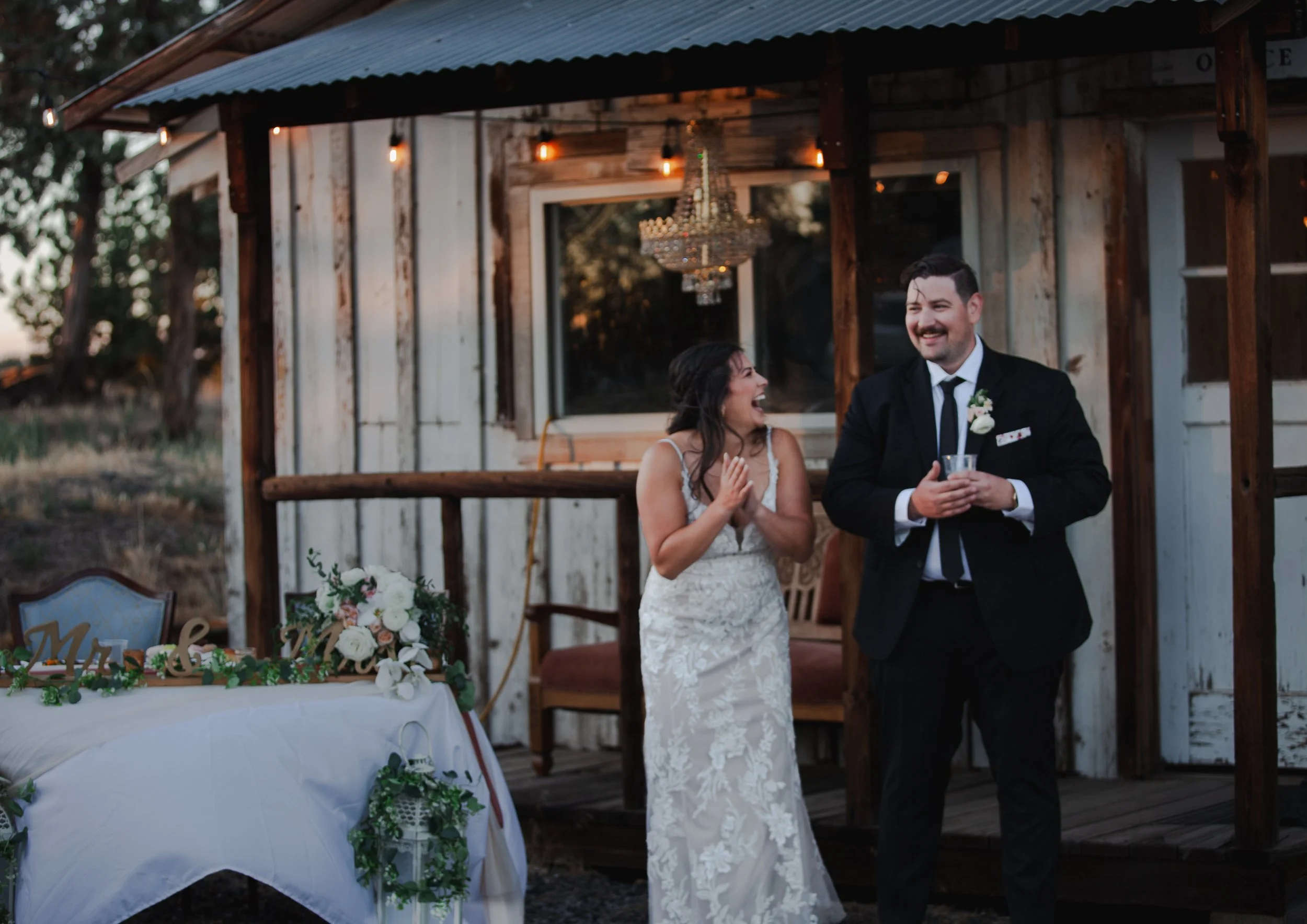  Bride and groom laughing during wedding toasts at their private ranch reception in Bend, Oregon 