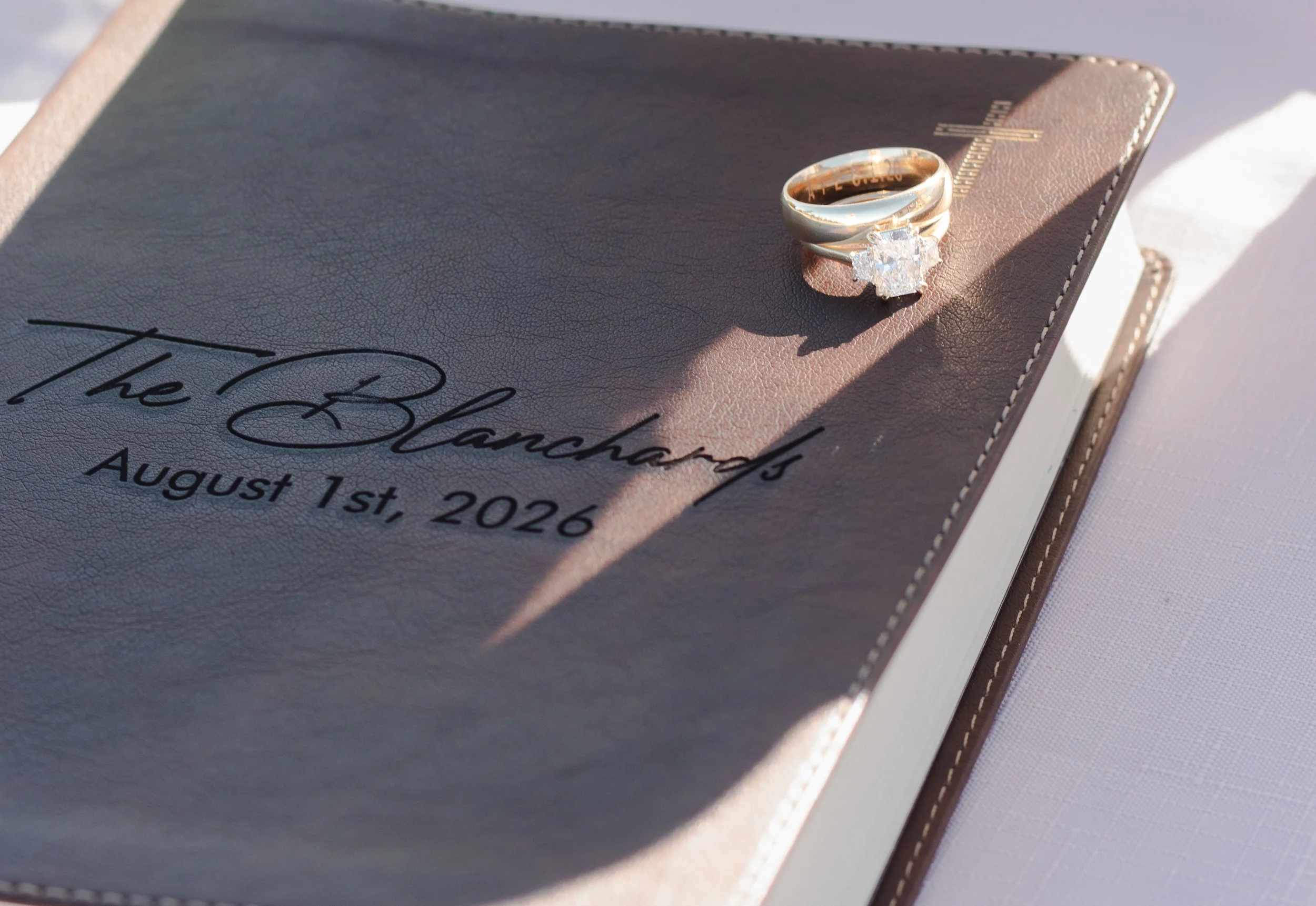  Wedding rings photographed on a personalized Blanchards wedding album at their Bend, Oregon ranch wedding 