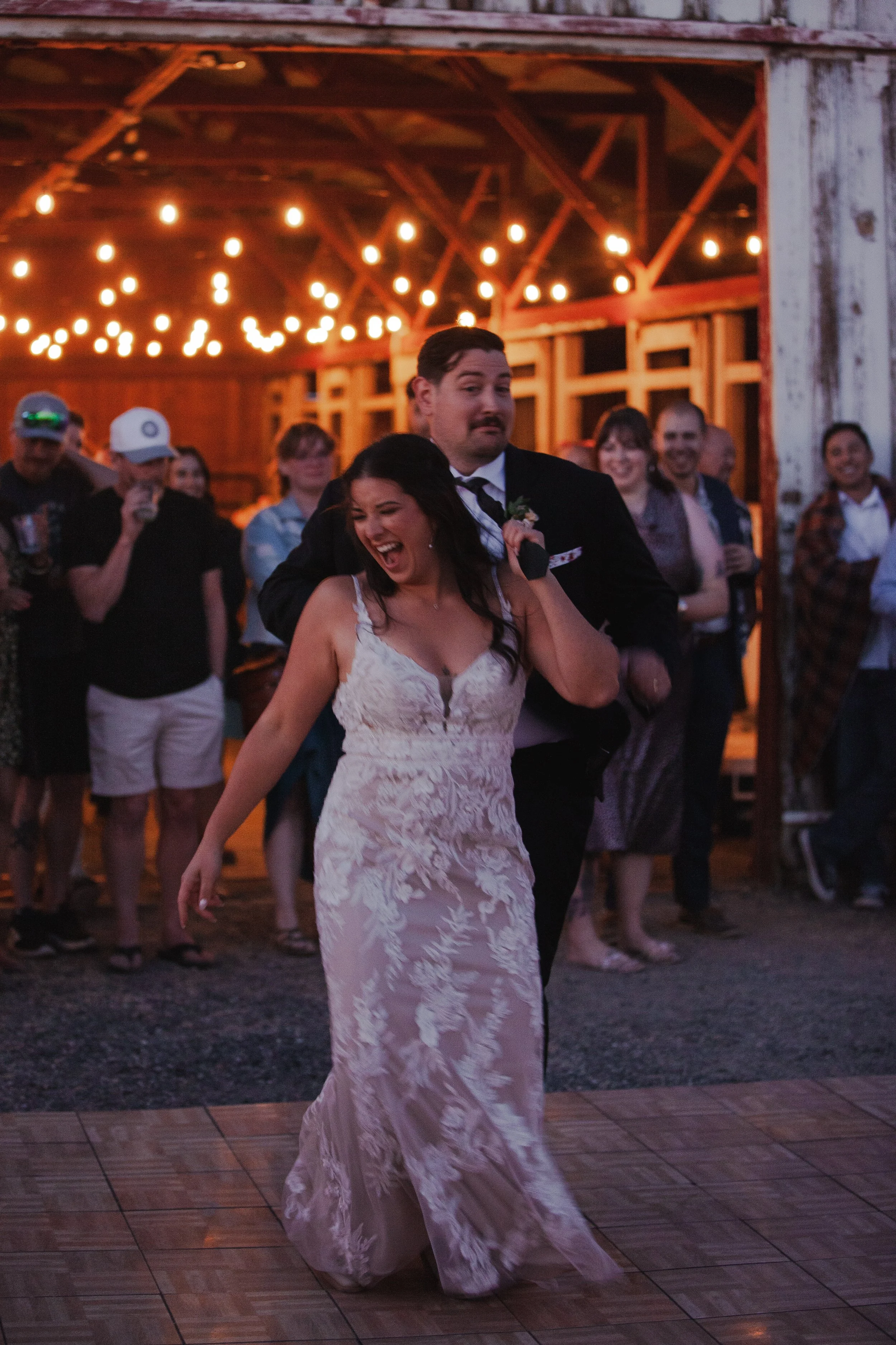  Bride and groom dancing beneath string lights at their private ranch wedding reception near Bend, Oregon 